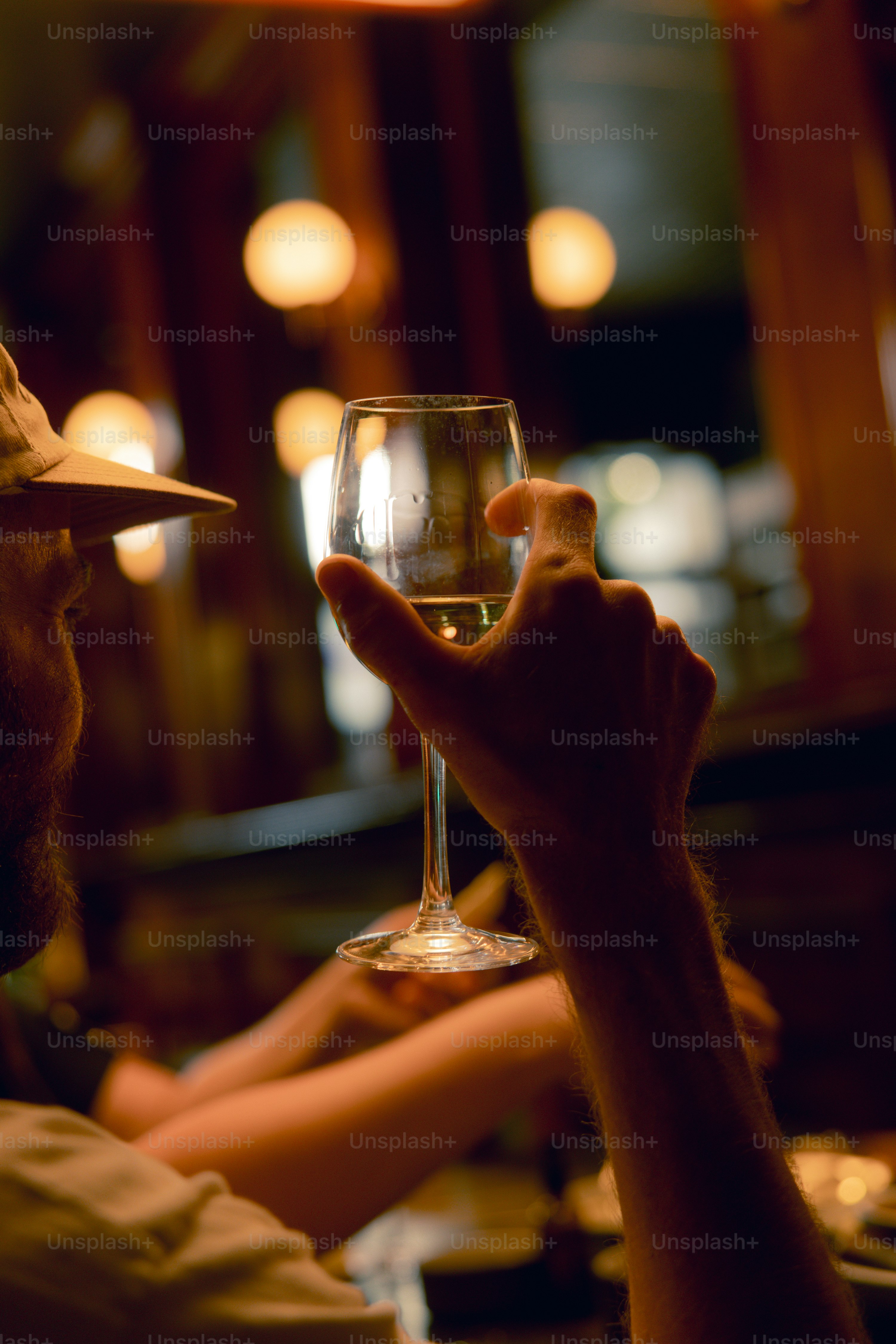 A man holding a glass of wine in his hand