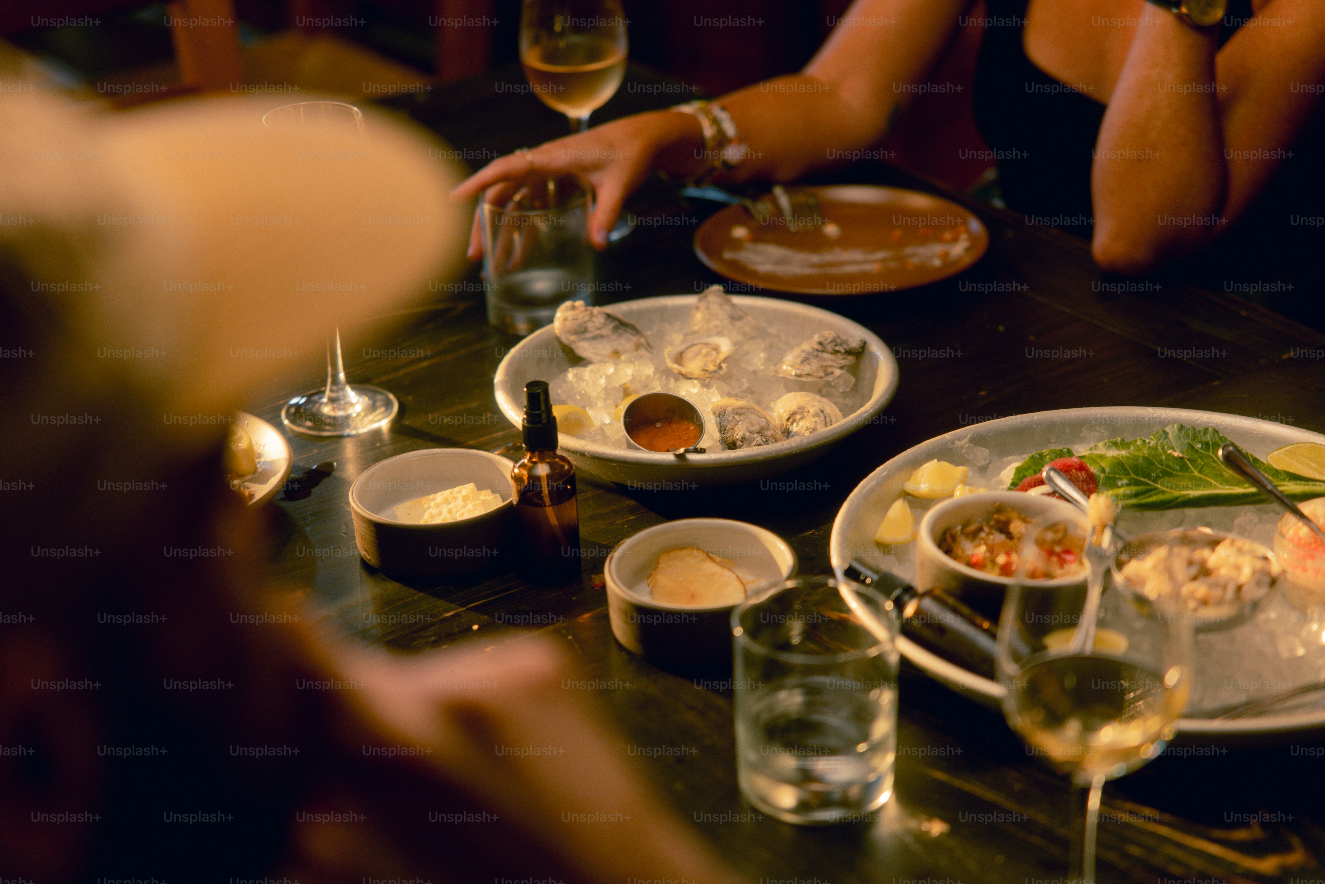 A group of people sitting at a table with plates of food