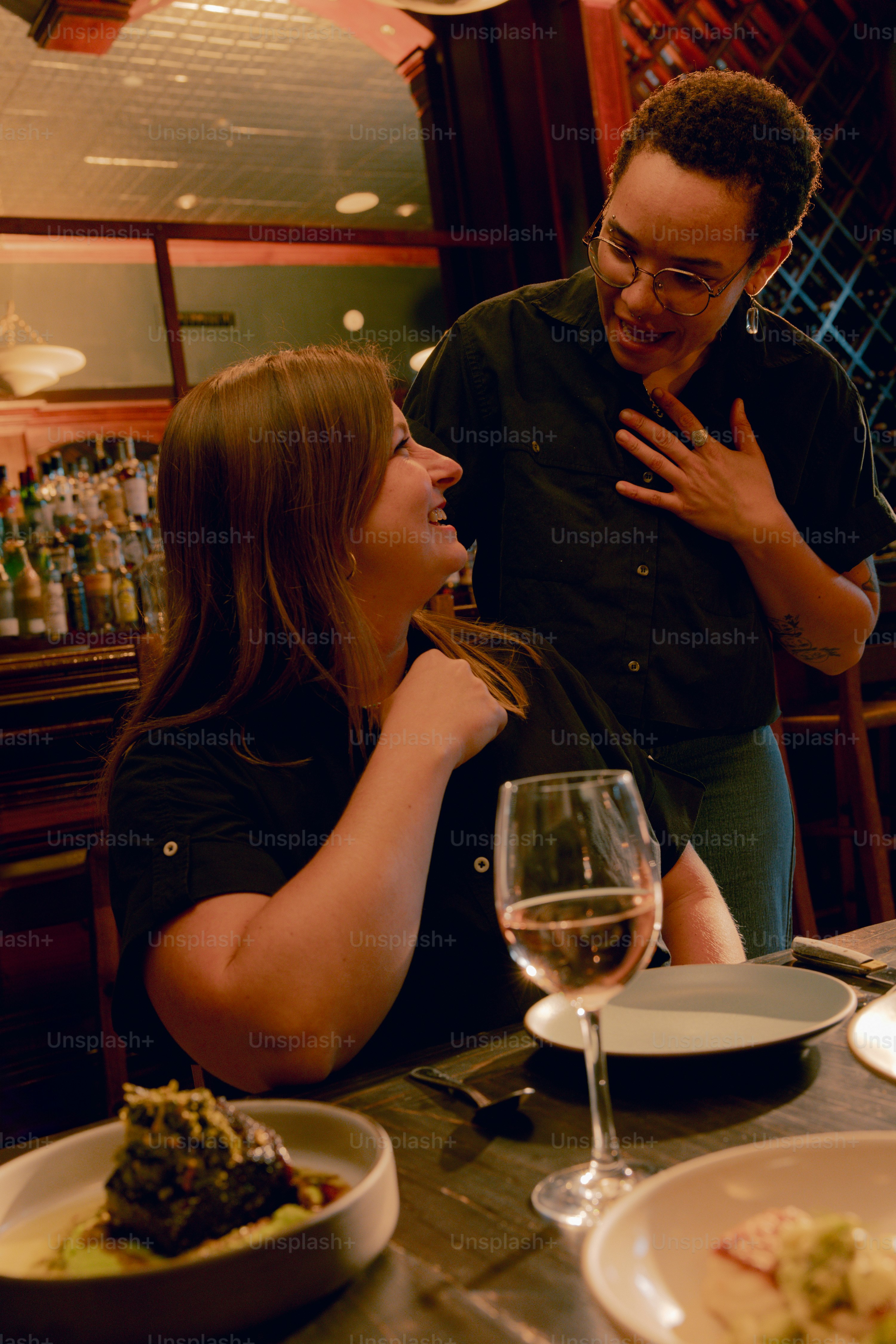 A man and a woman sitting at a table in a restaurant