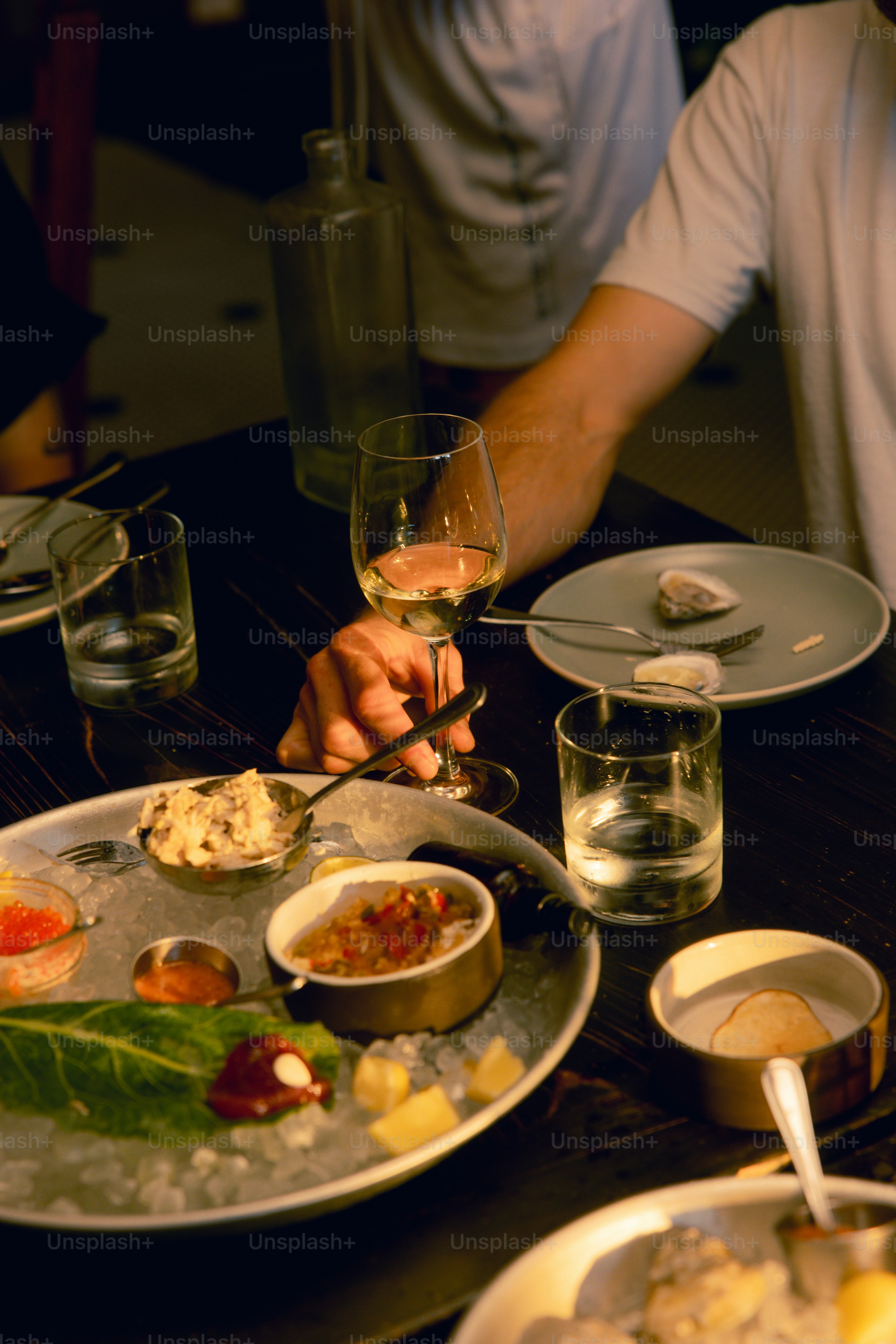 A man sitting at a table with a plate of food