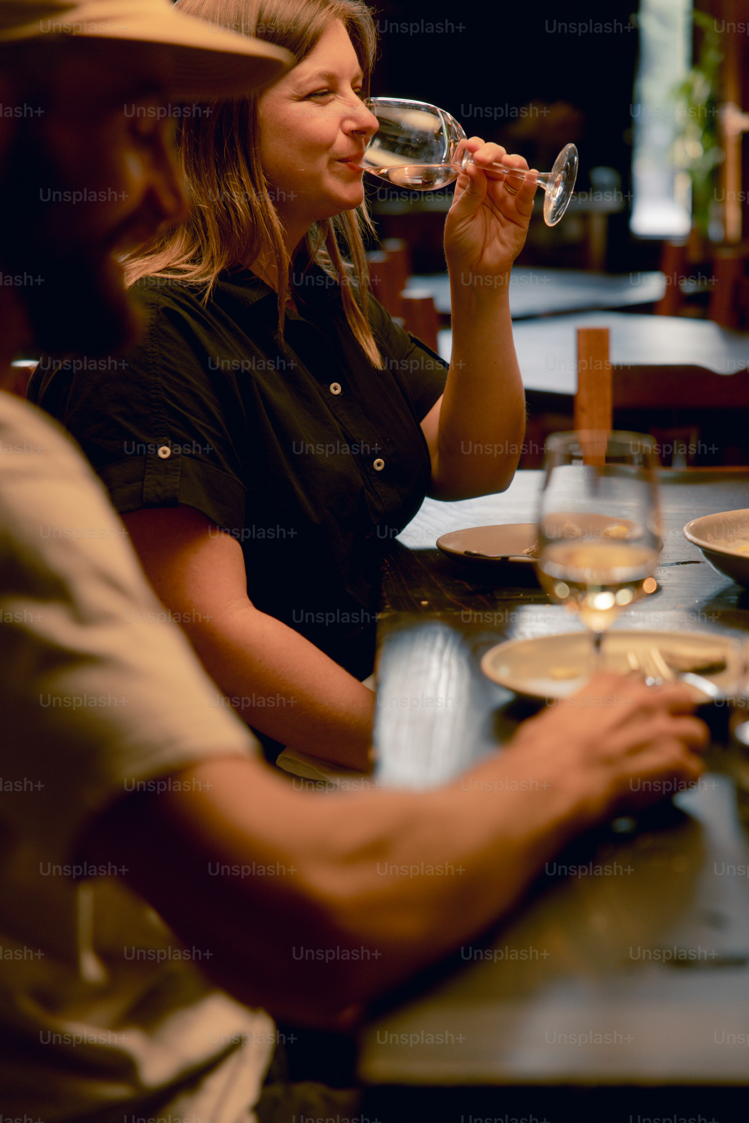 A group of people sitting at a table drinking wine