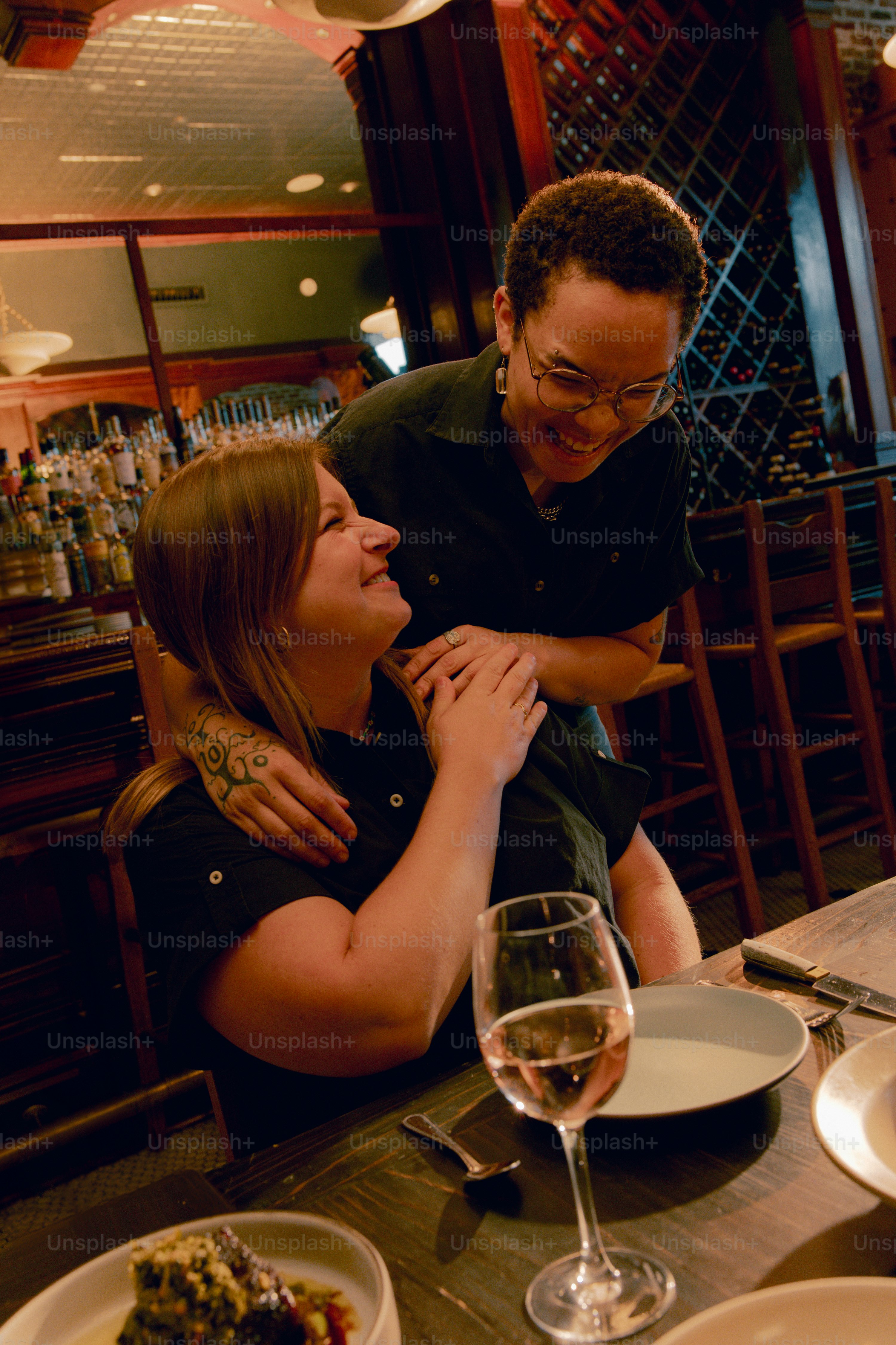 A man and woman sitting at a table in a restaurant