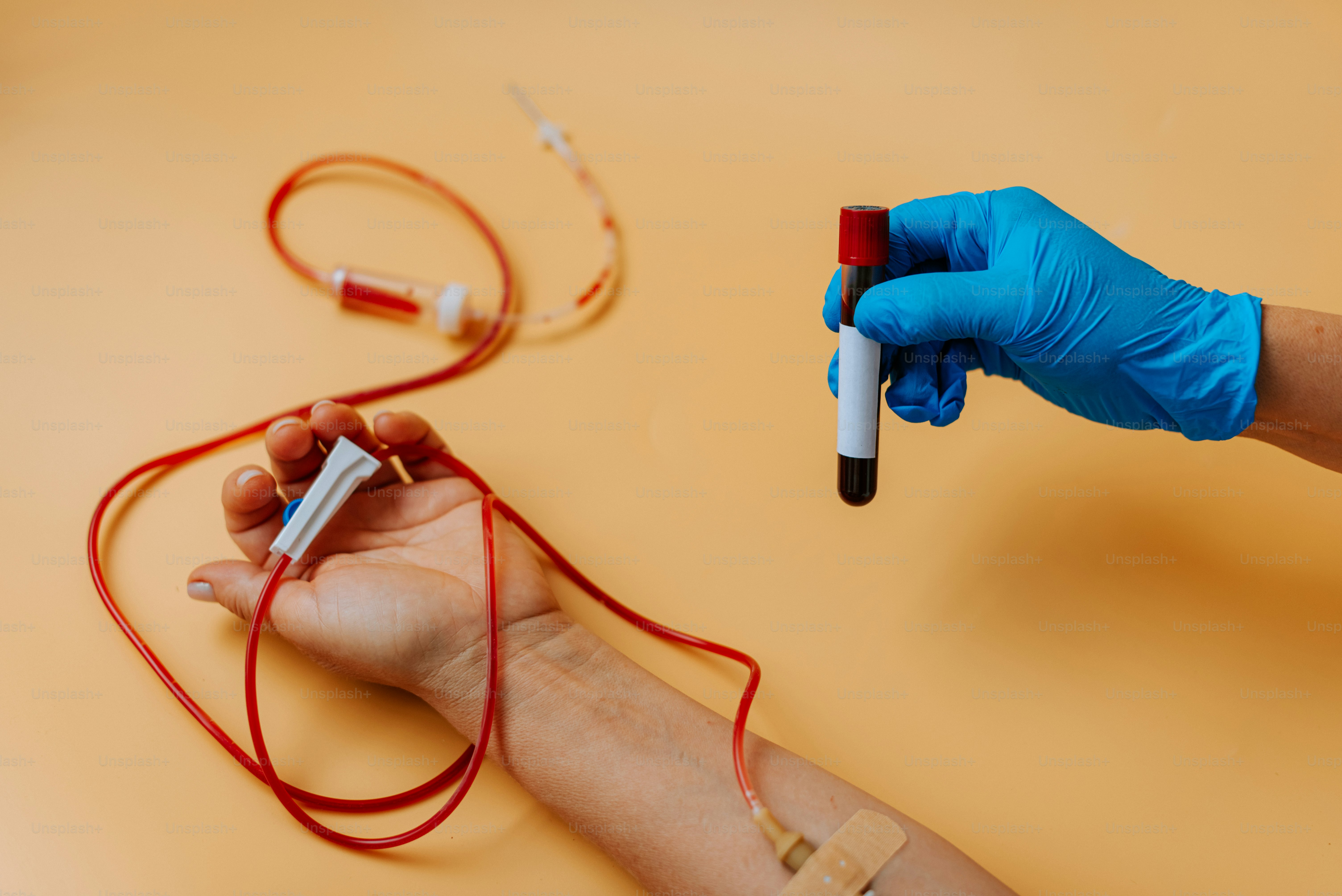 A person in blue gloves is holding a blood test