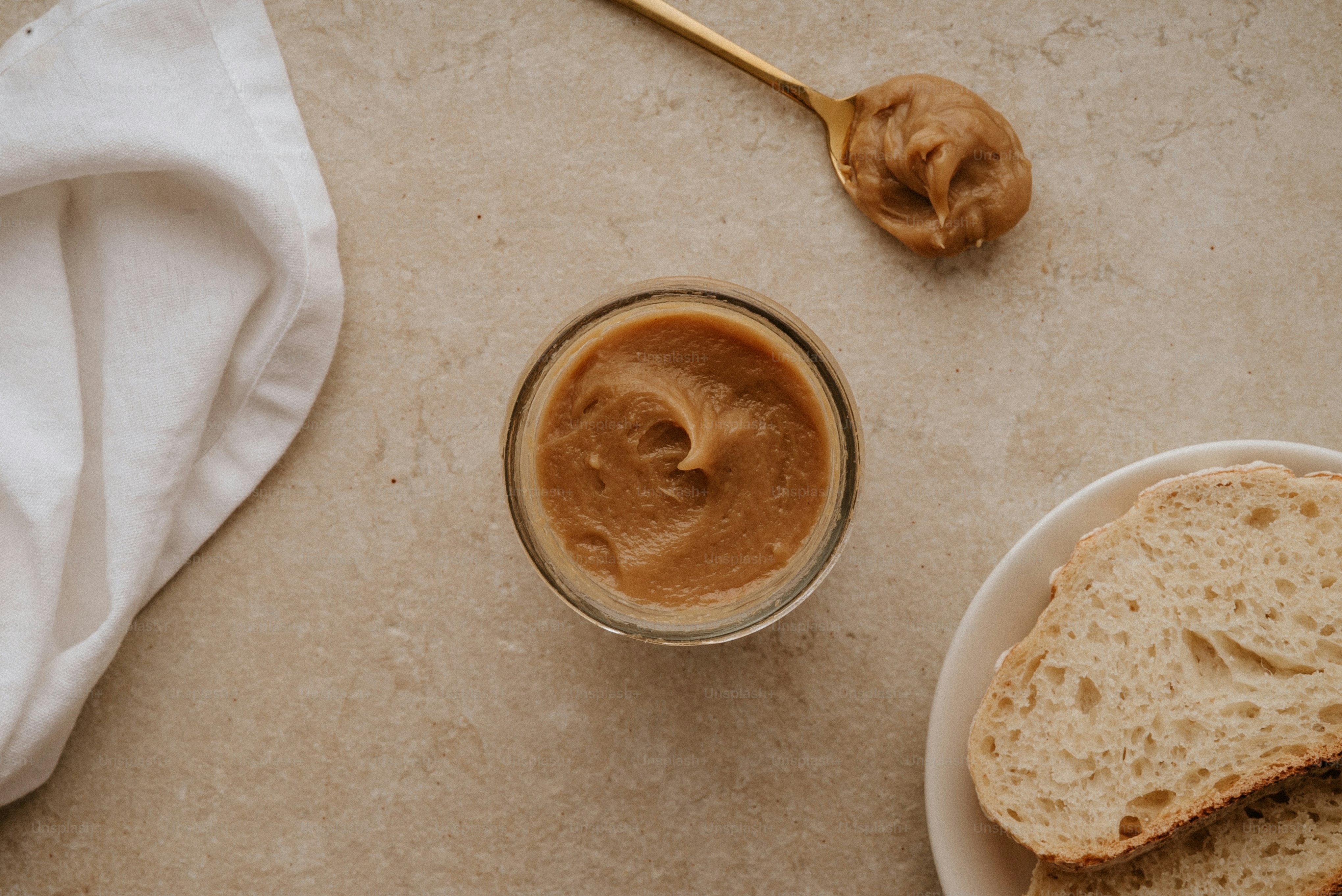 Peanut butter and a spoon on a table