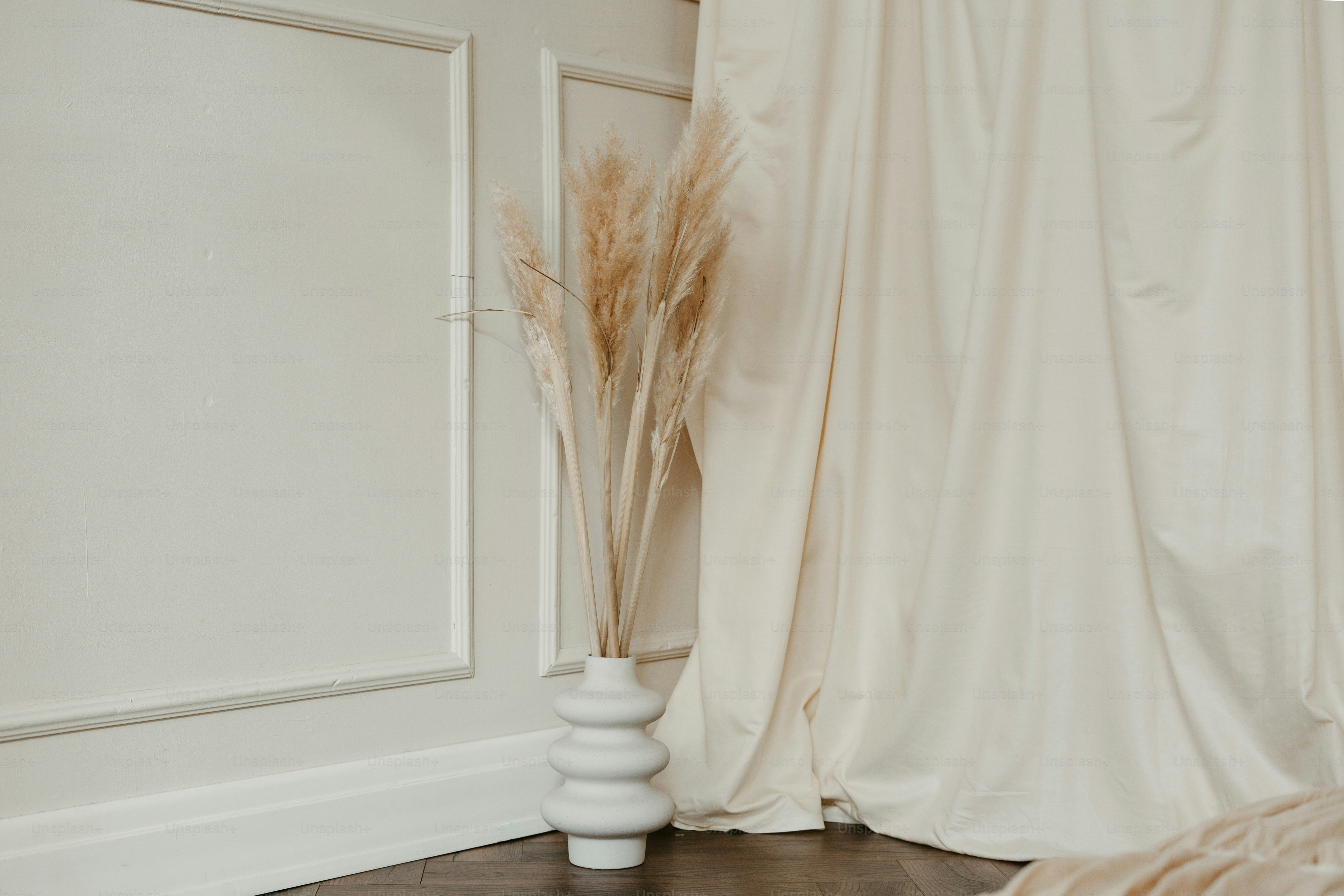 A room with a bed and a white curtain
