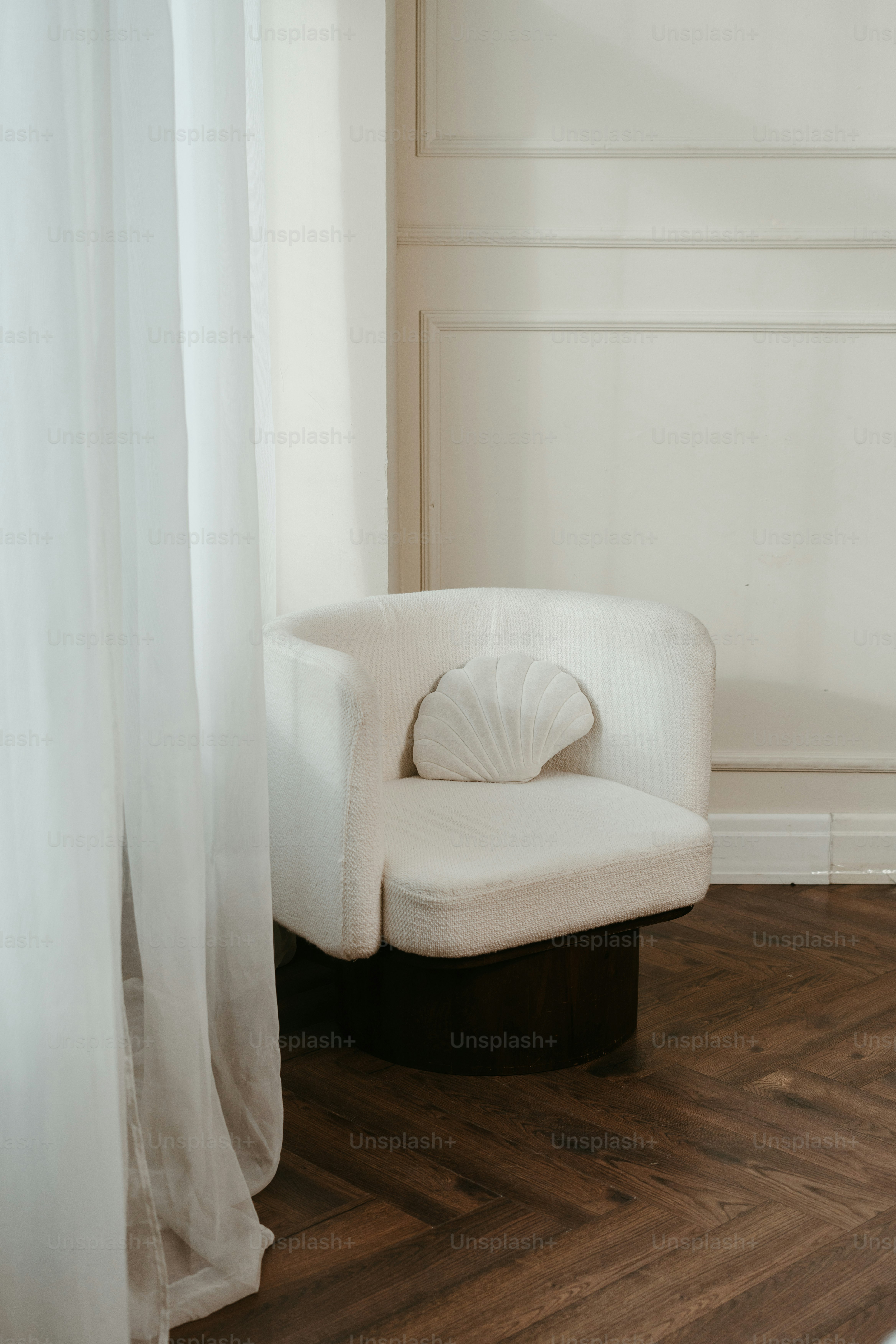 A white chair sitting on top of a hard wood floor