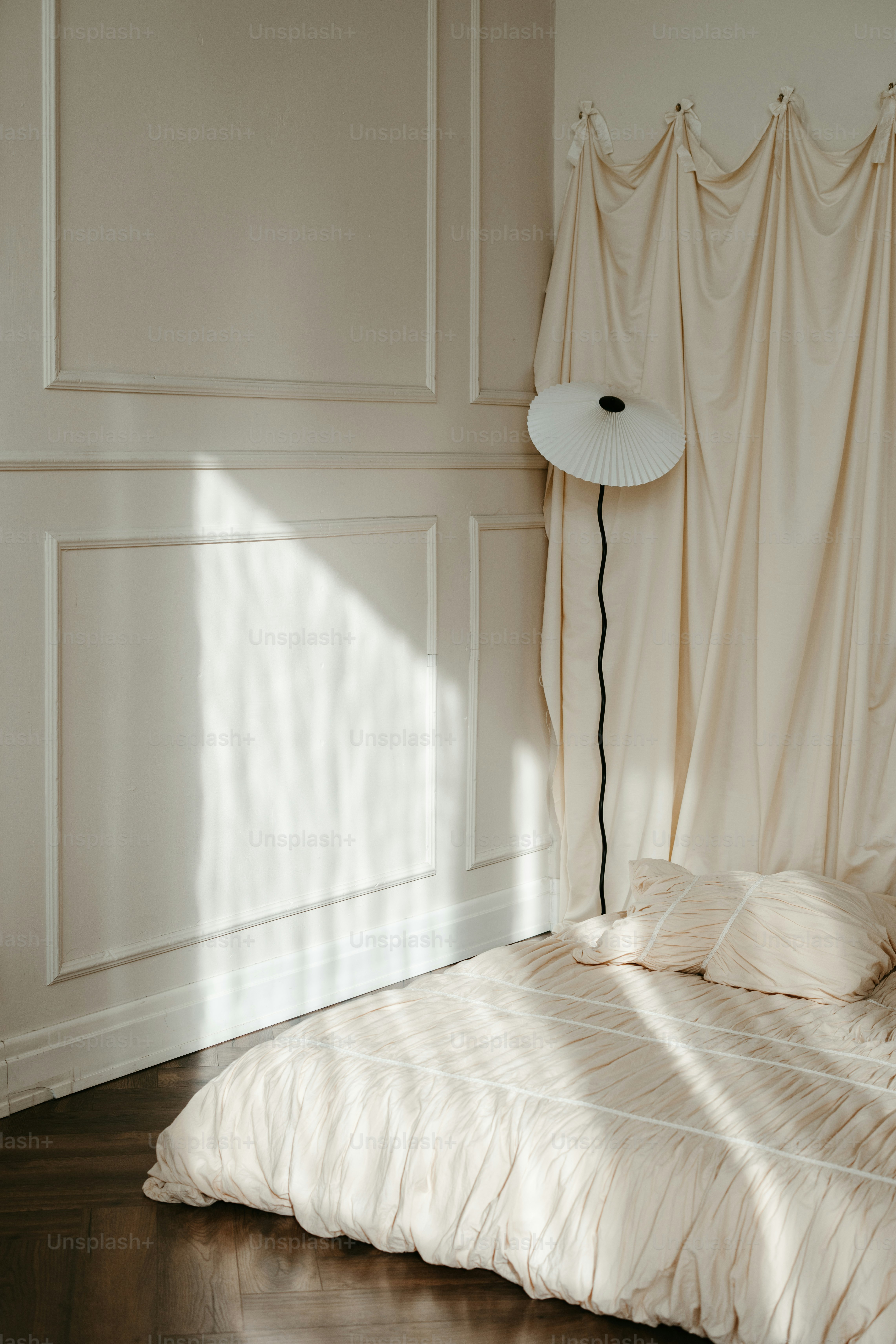 A bedroom with a bed and a lamp