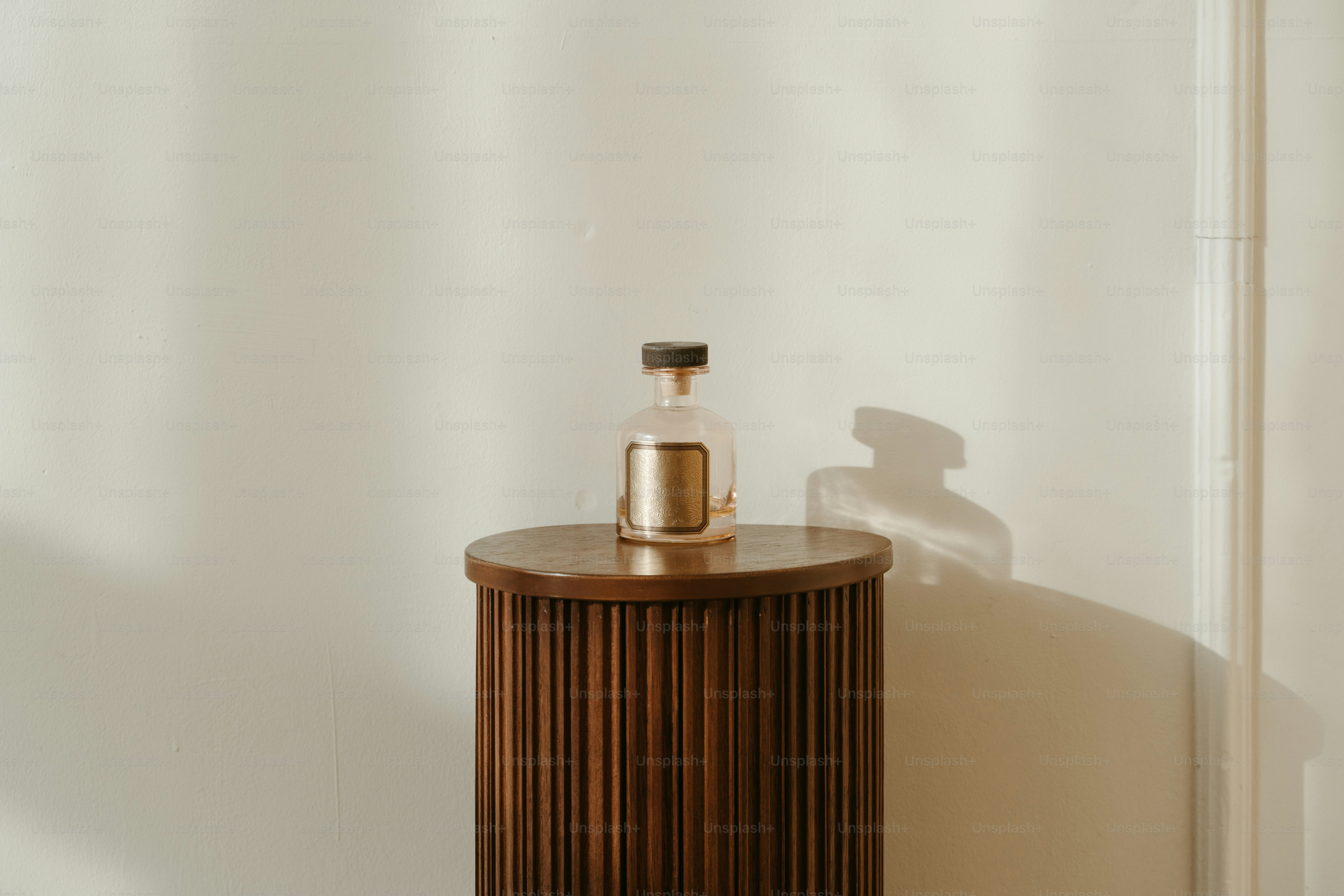 A wooden cabinet with a bottle on top of it