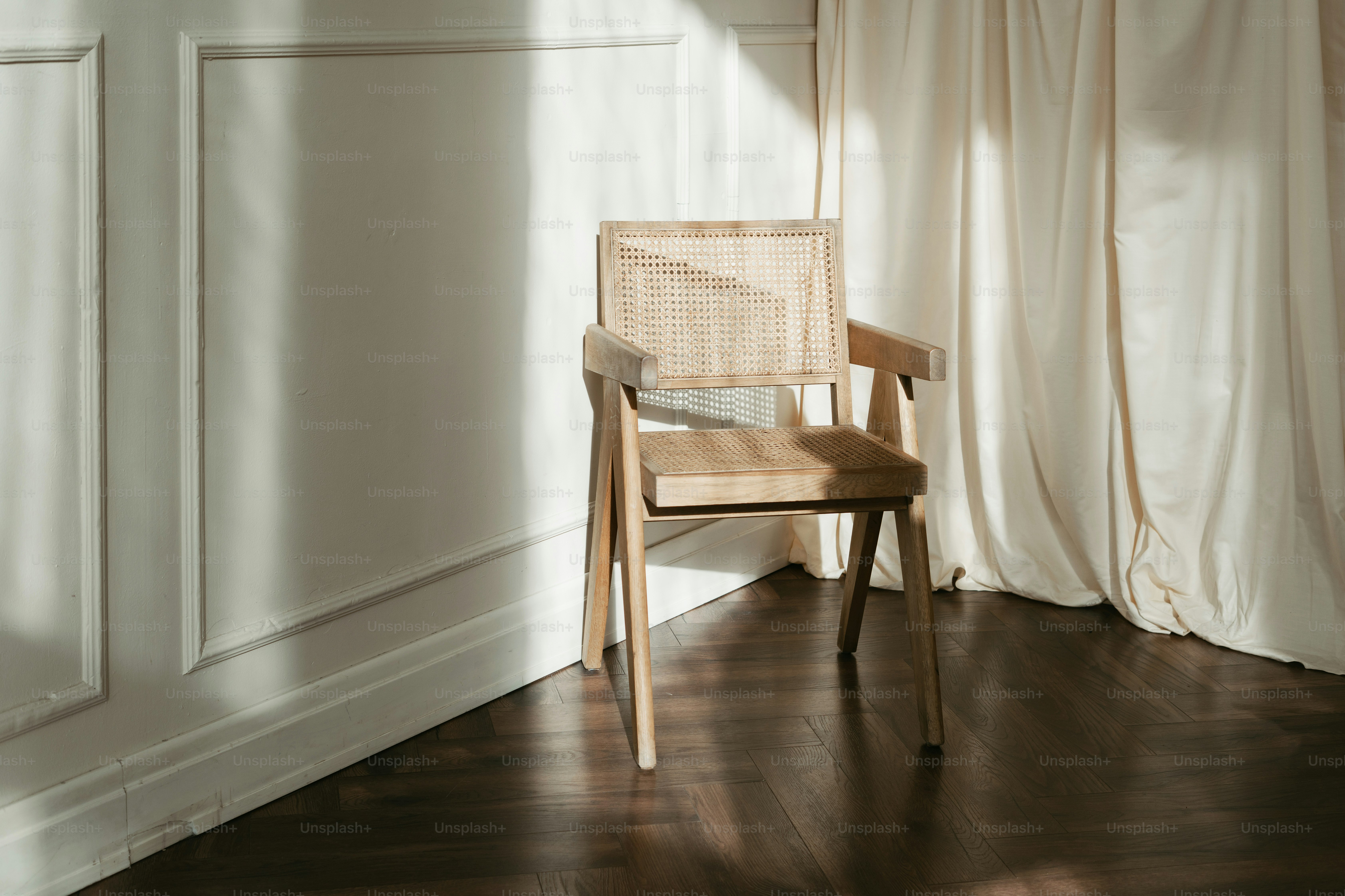 A wooden chair sitting in front of a window