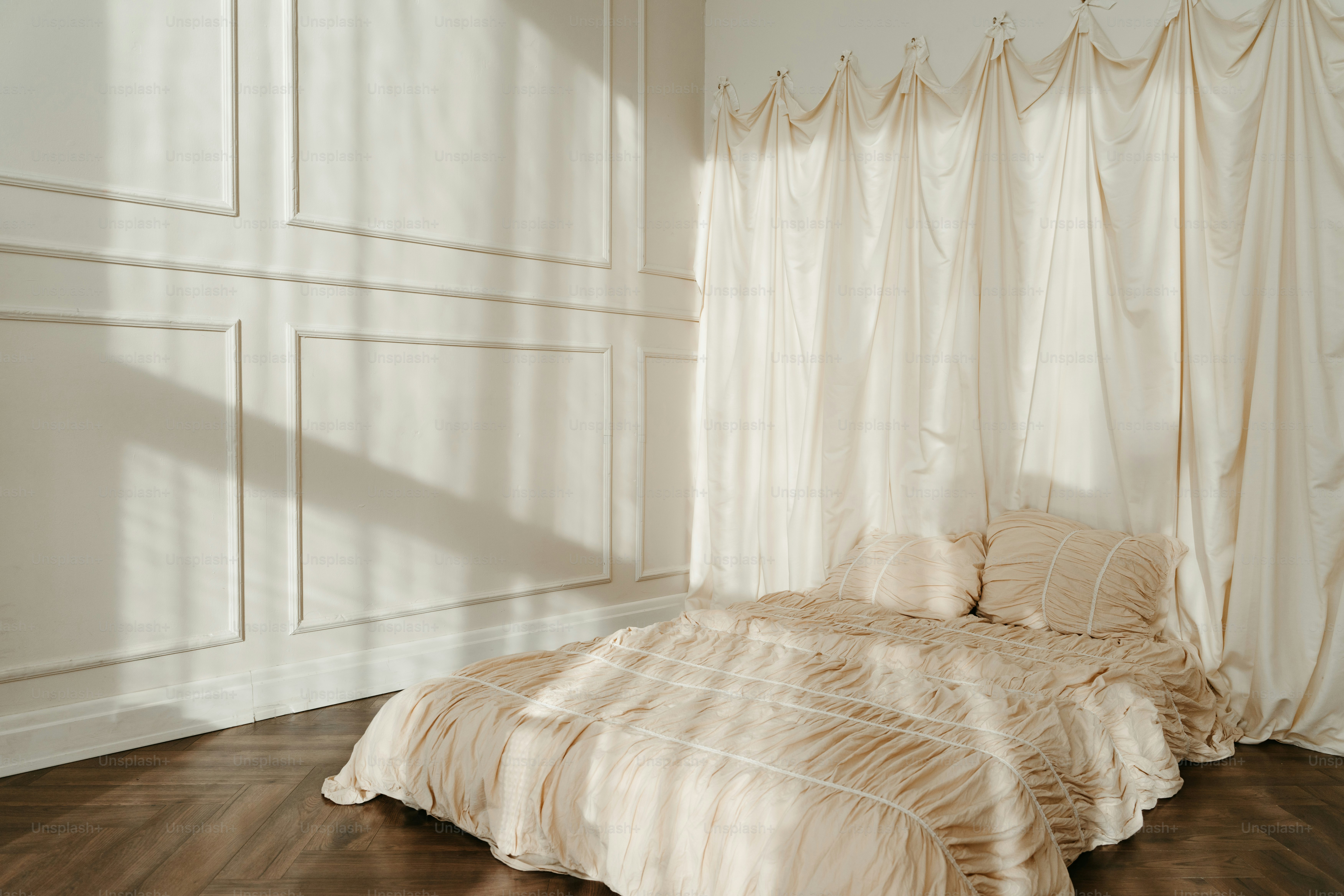 A bed sitting in a bedroom next to a window