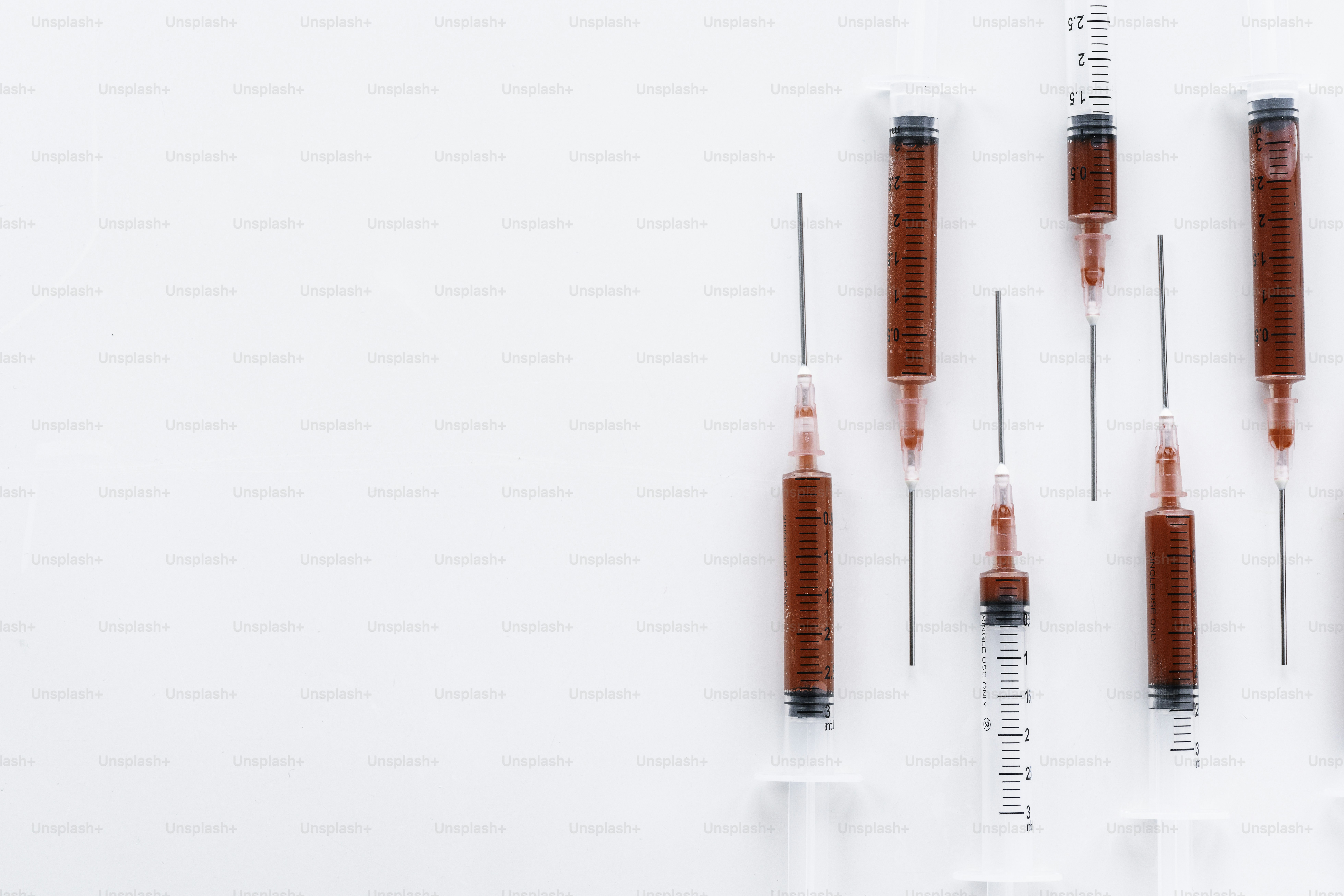 A group of red and clear medical syensils