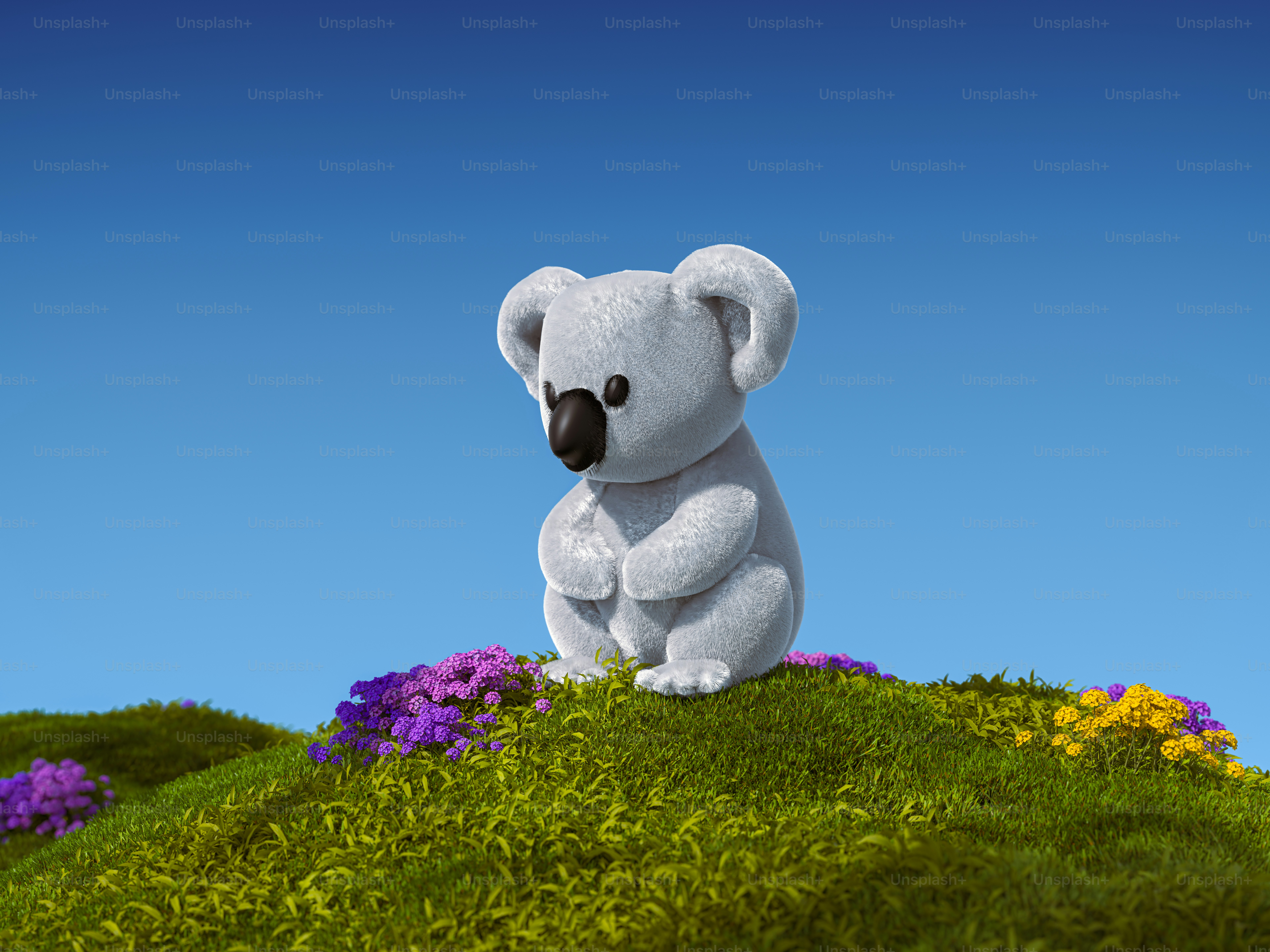 A white teddy bear sitting on top of a lush green hillside