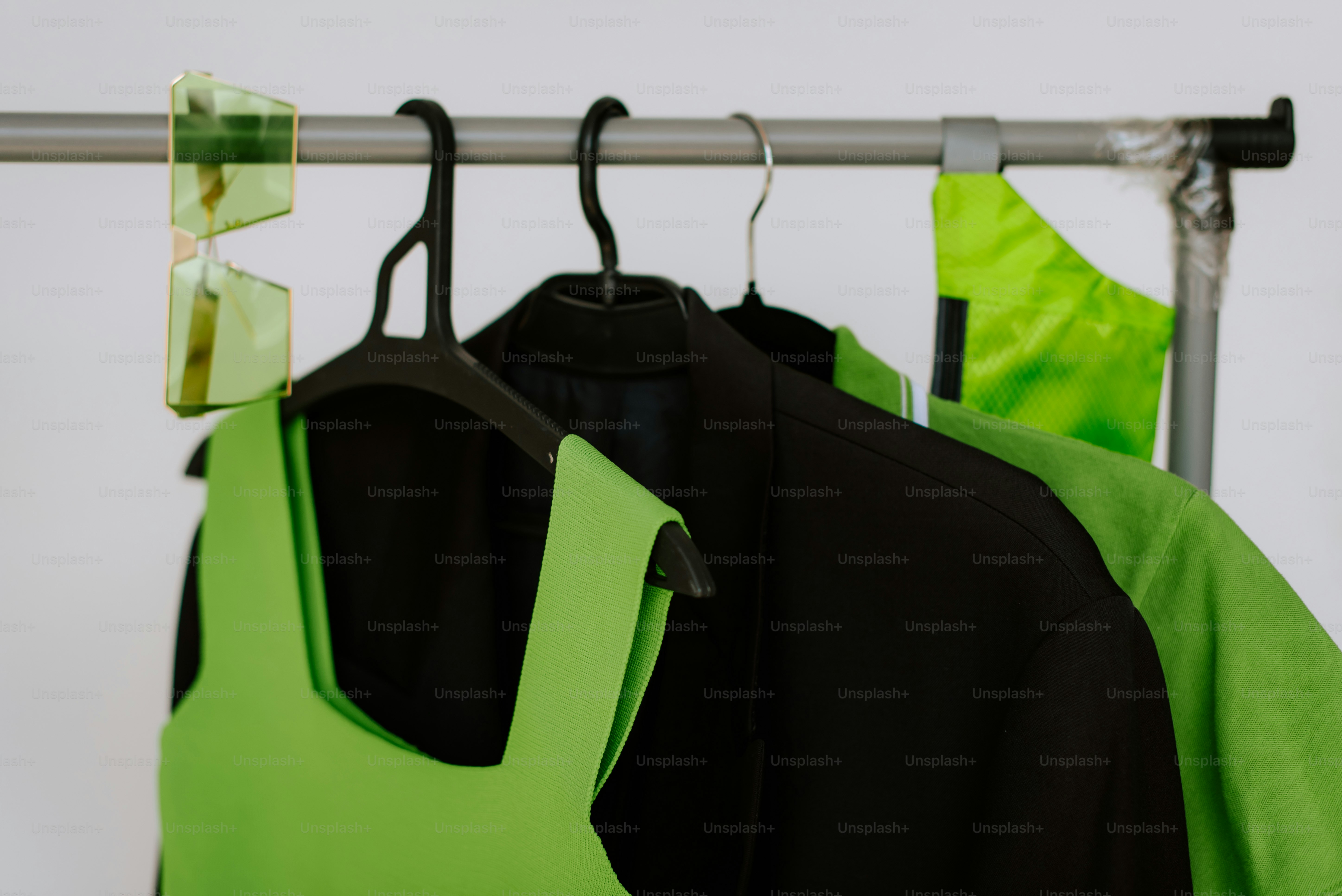 A rack with three shirts hanging on it