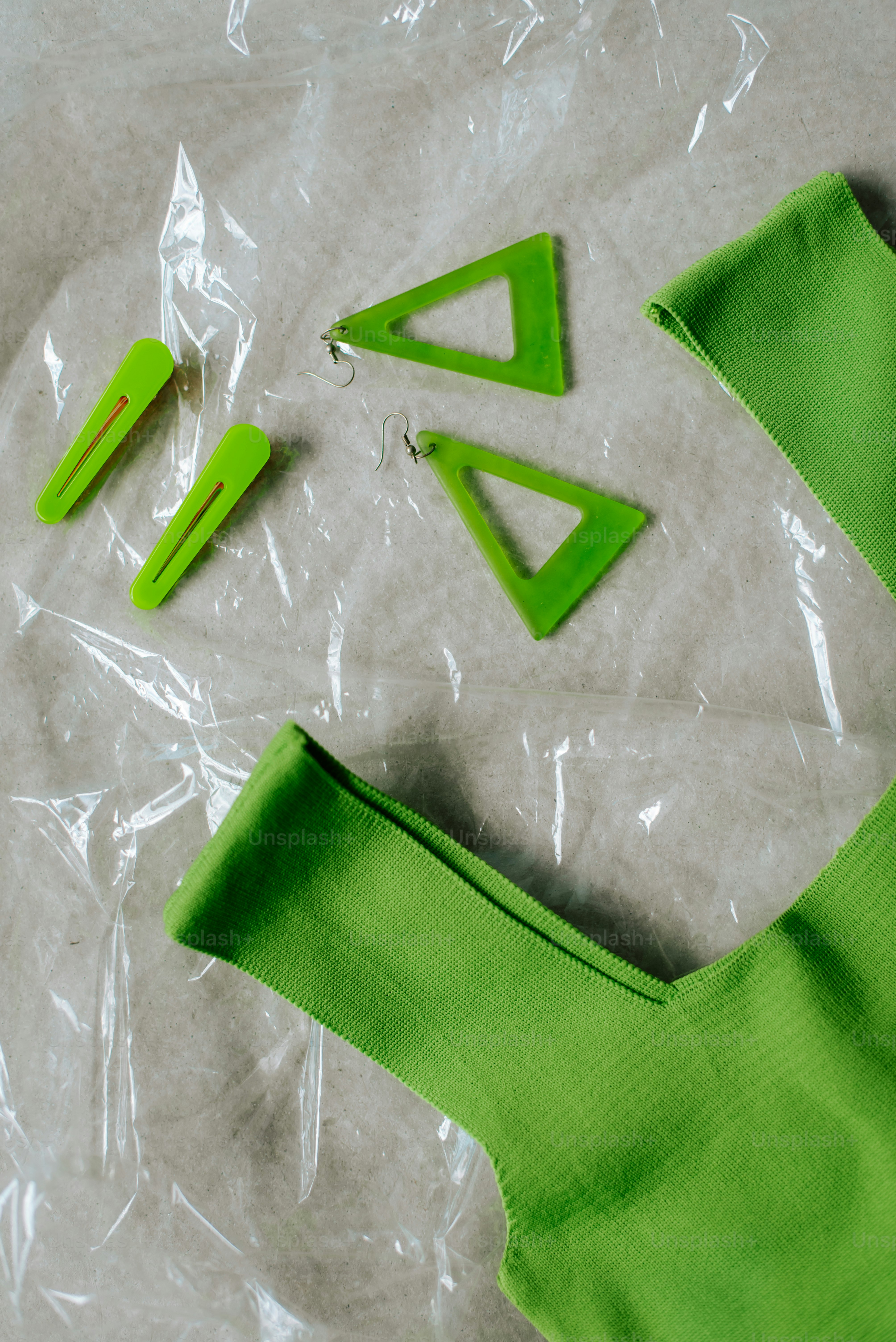 A pair of scissors and a green piece of clothing