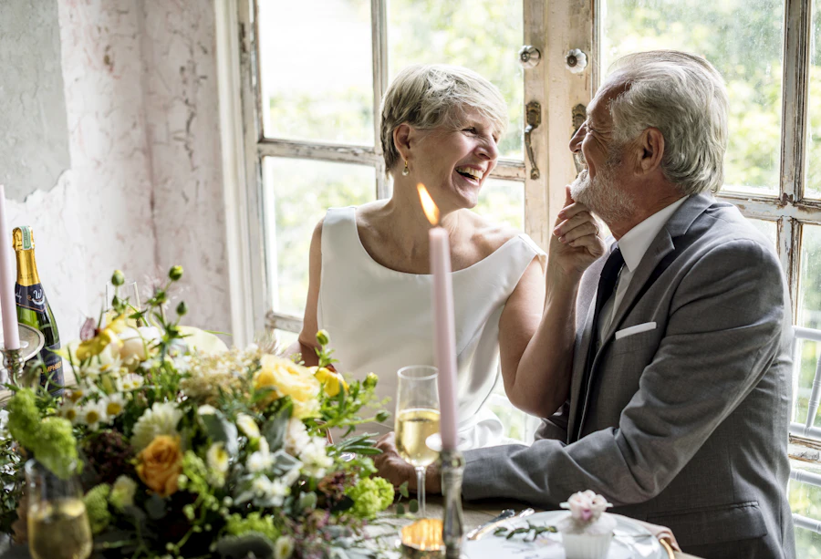 two older women sitting together at kitchen table talking seriously one listening intently warm natural home setting afternoon light sincere conversation