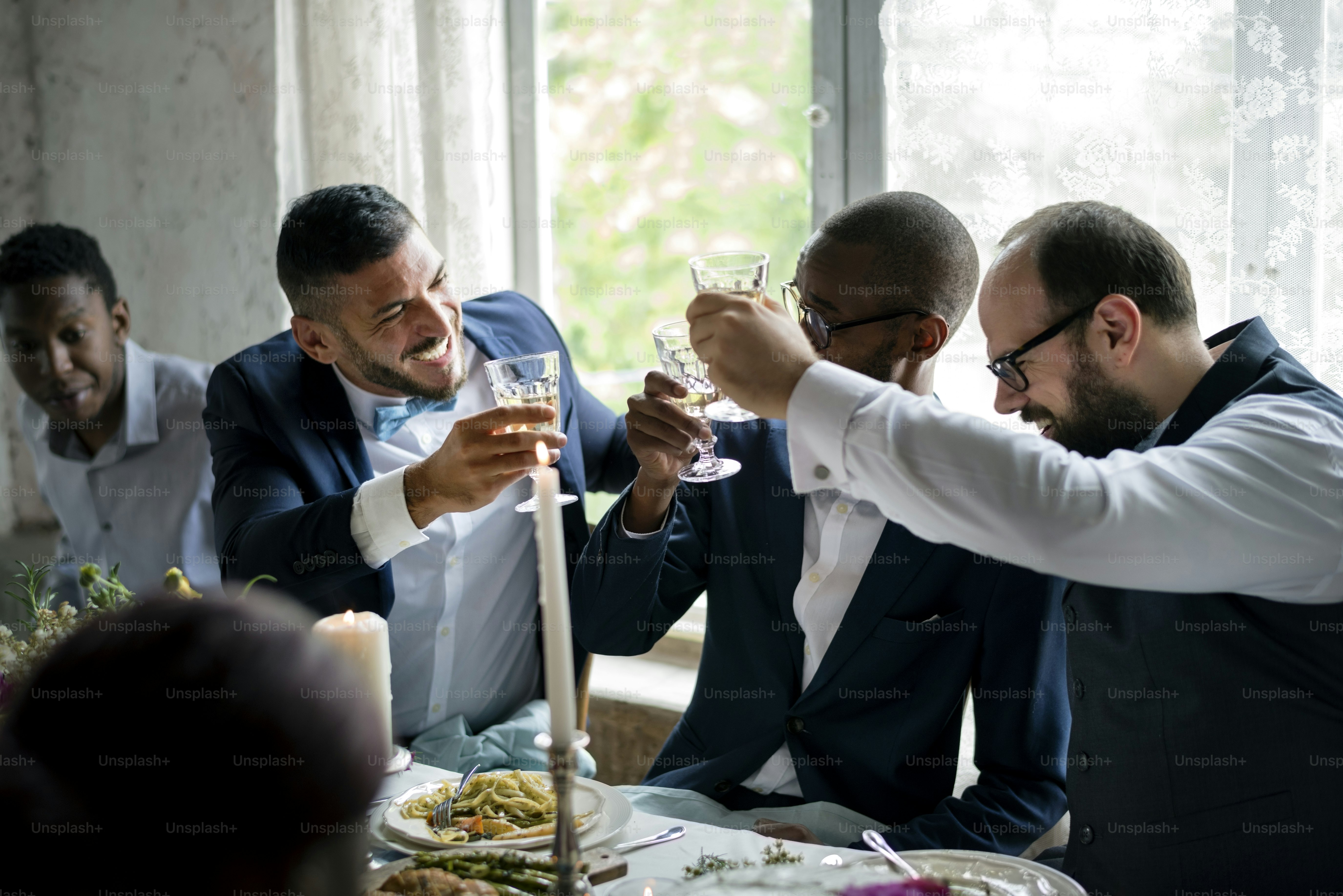 Diverse men clinking a drink together