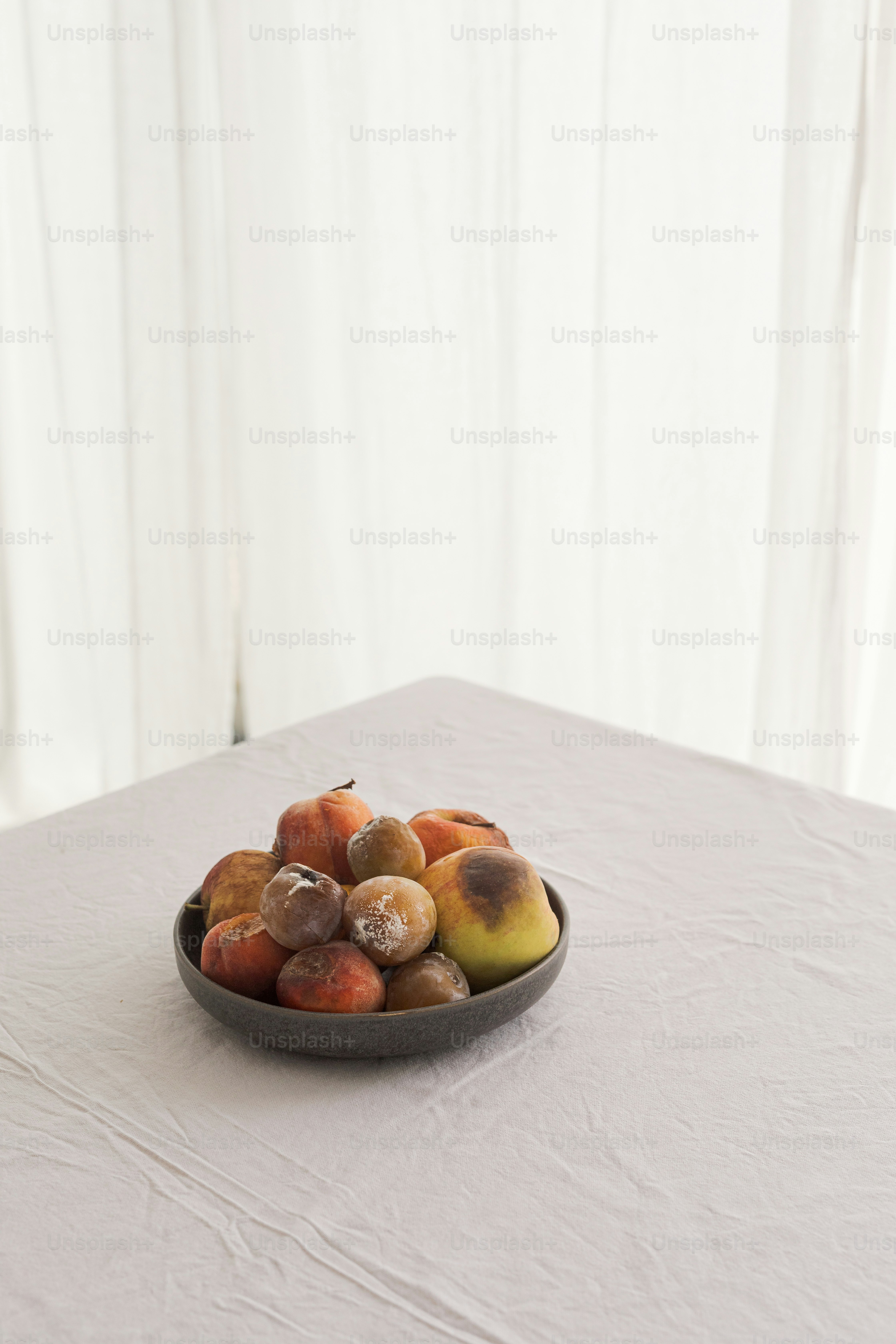 A bowl of fruit is sitting on a table