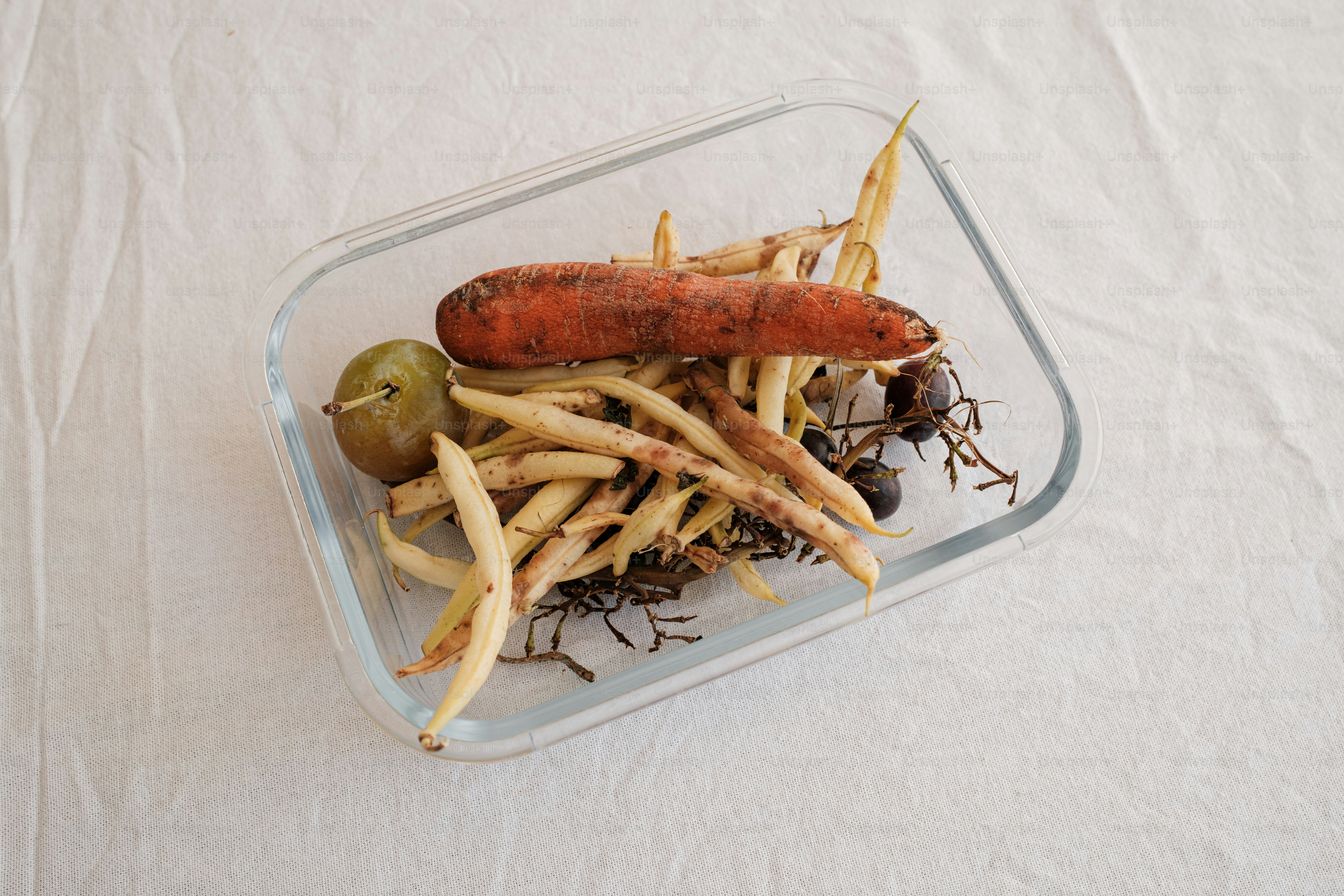 A hot dog and french fries in a plastic container
