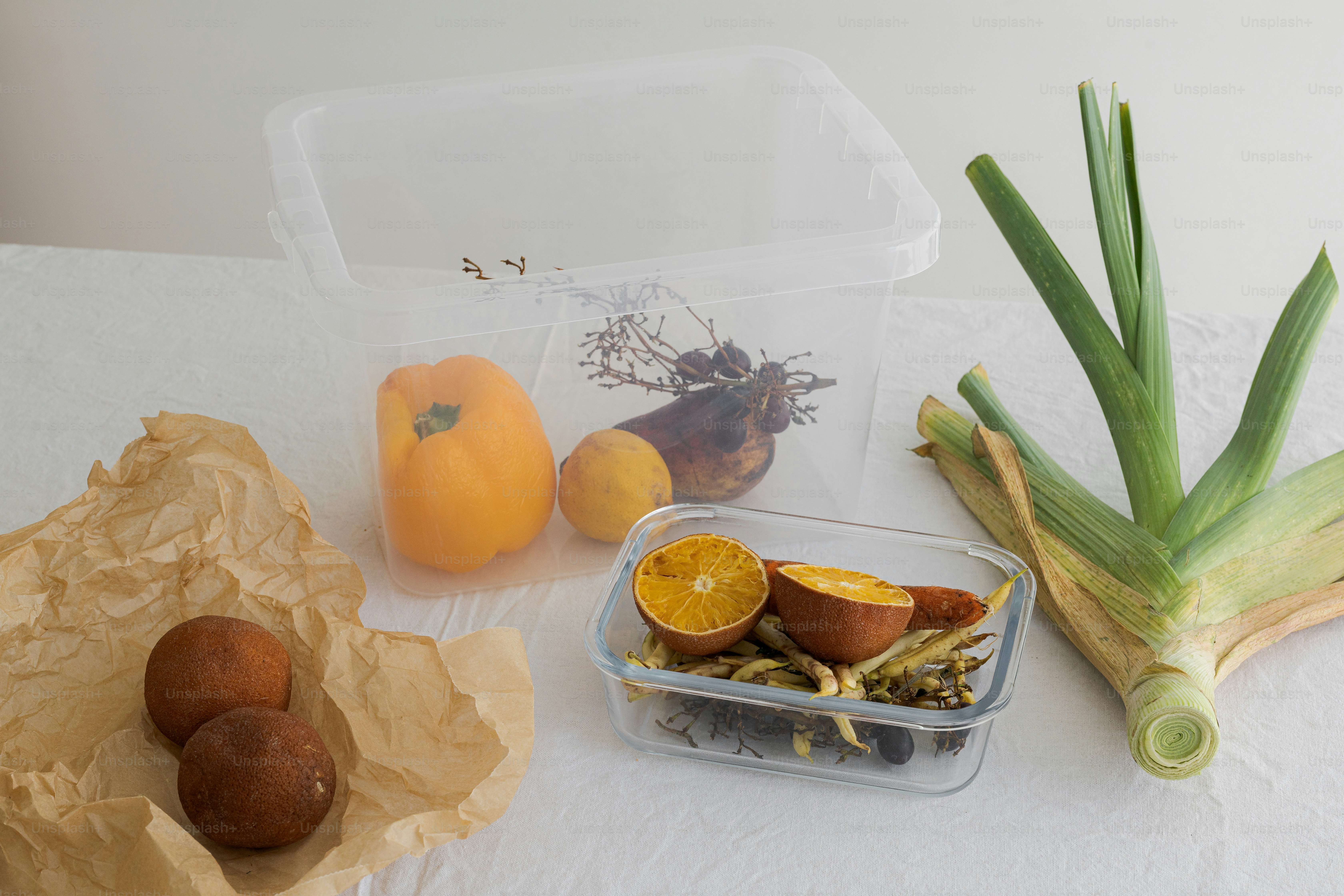 A table topped with plastic containers filled with food