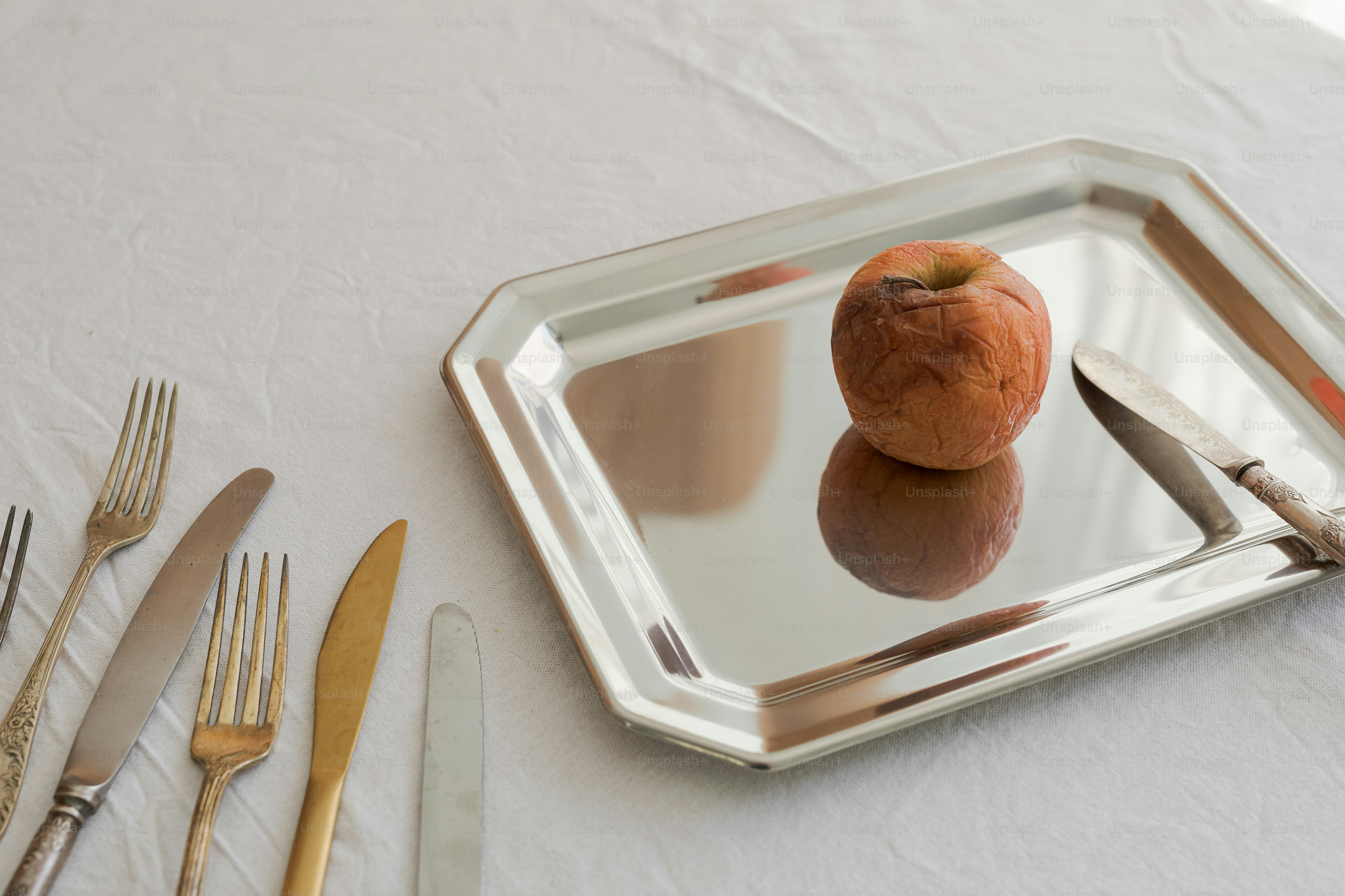 A table with a mirror and silverware on it