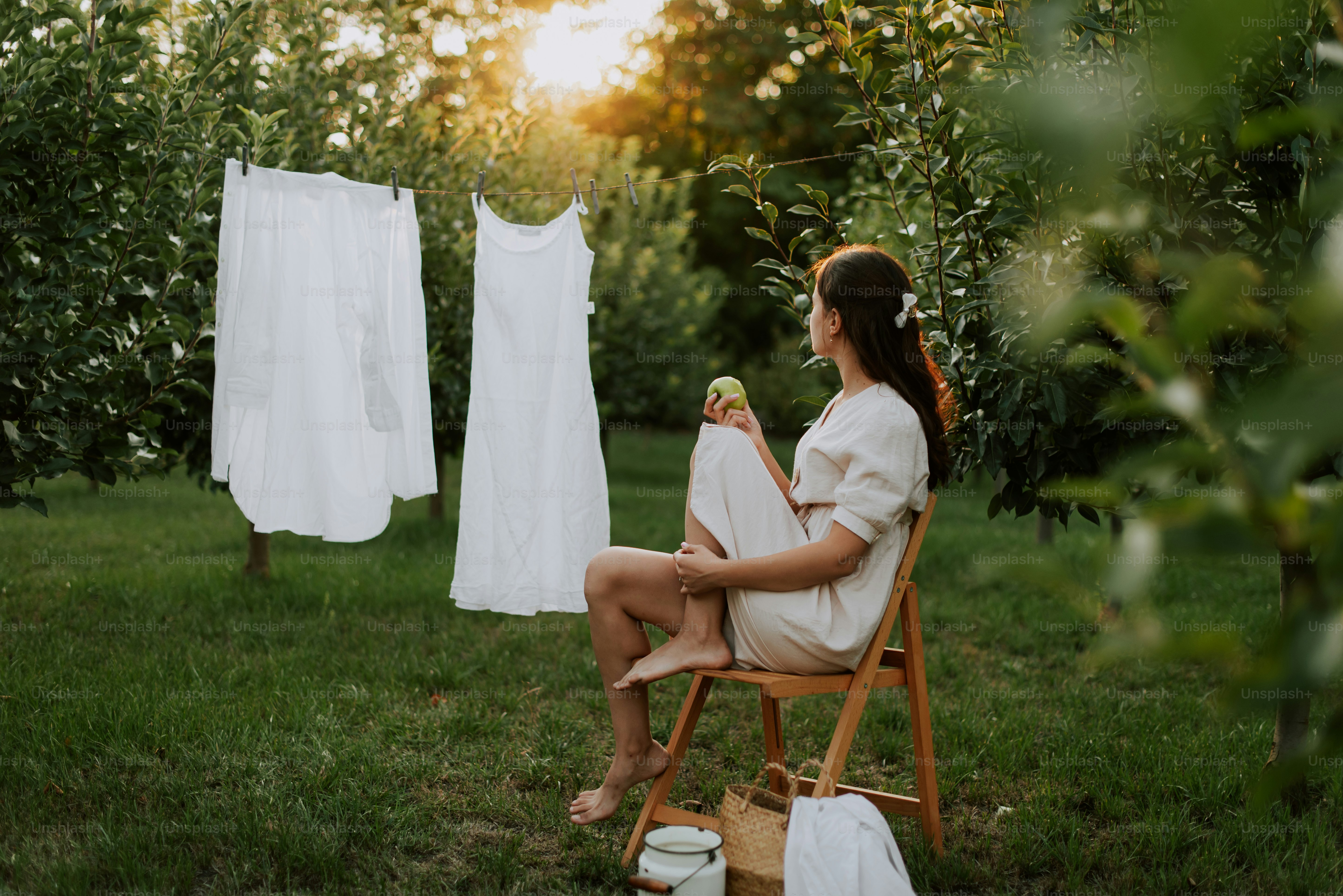 A woman sitting in a chair in the grass