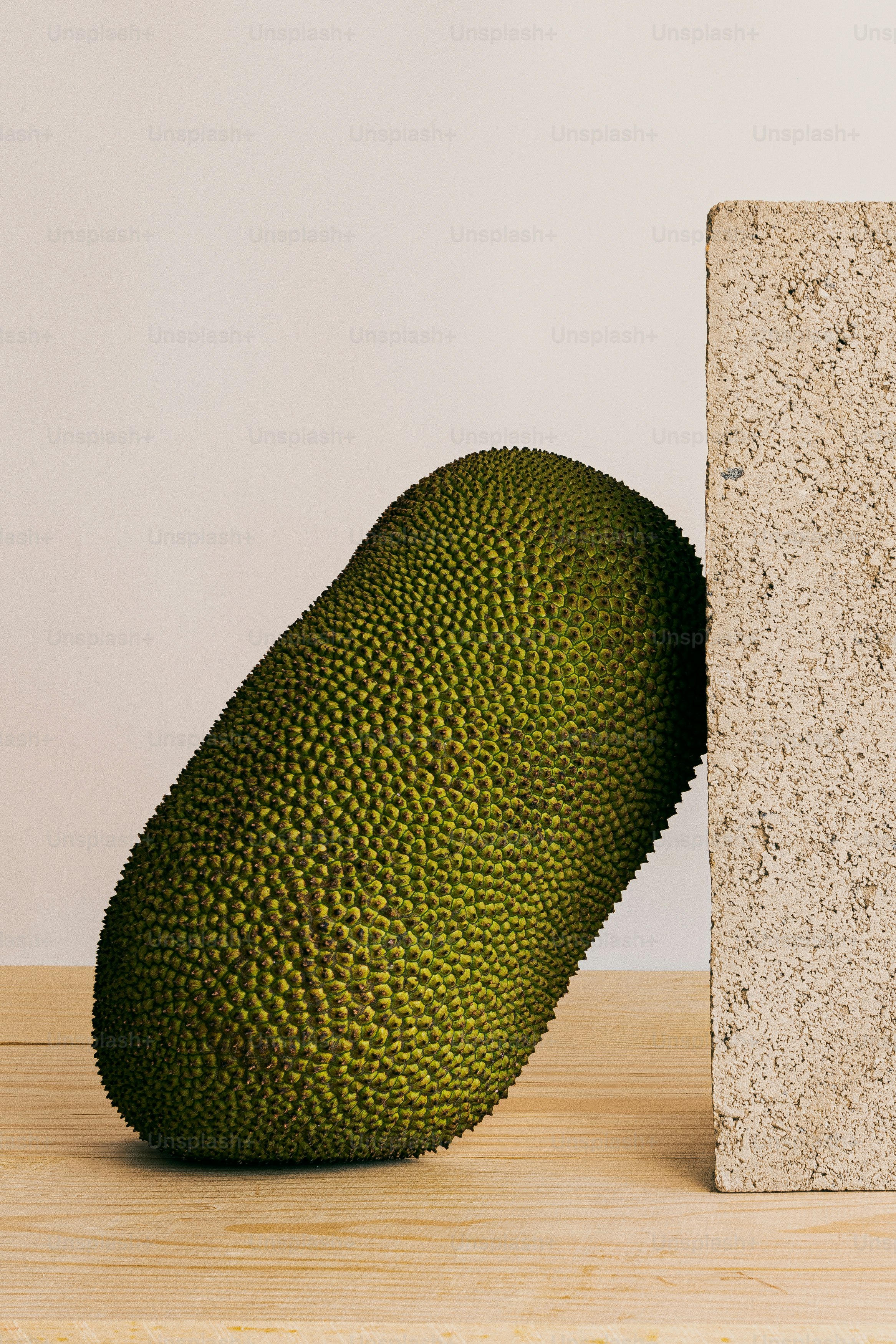 A green object sitting on top of a wooden table
