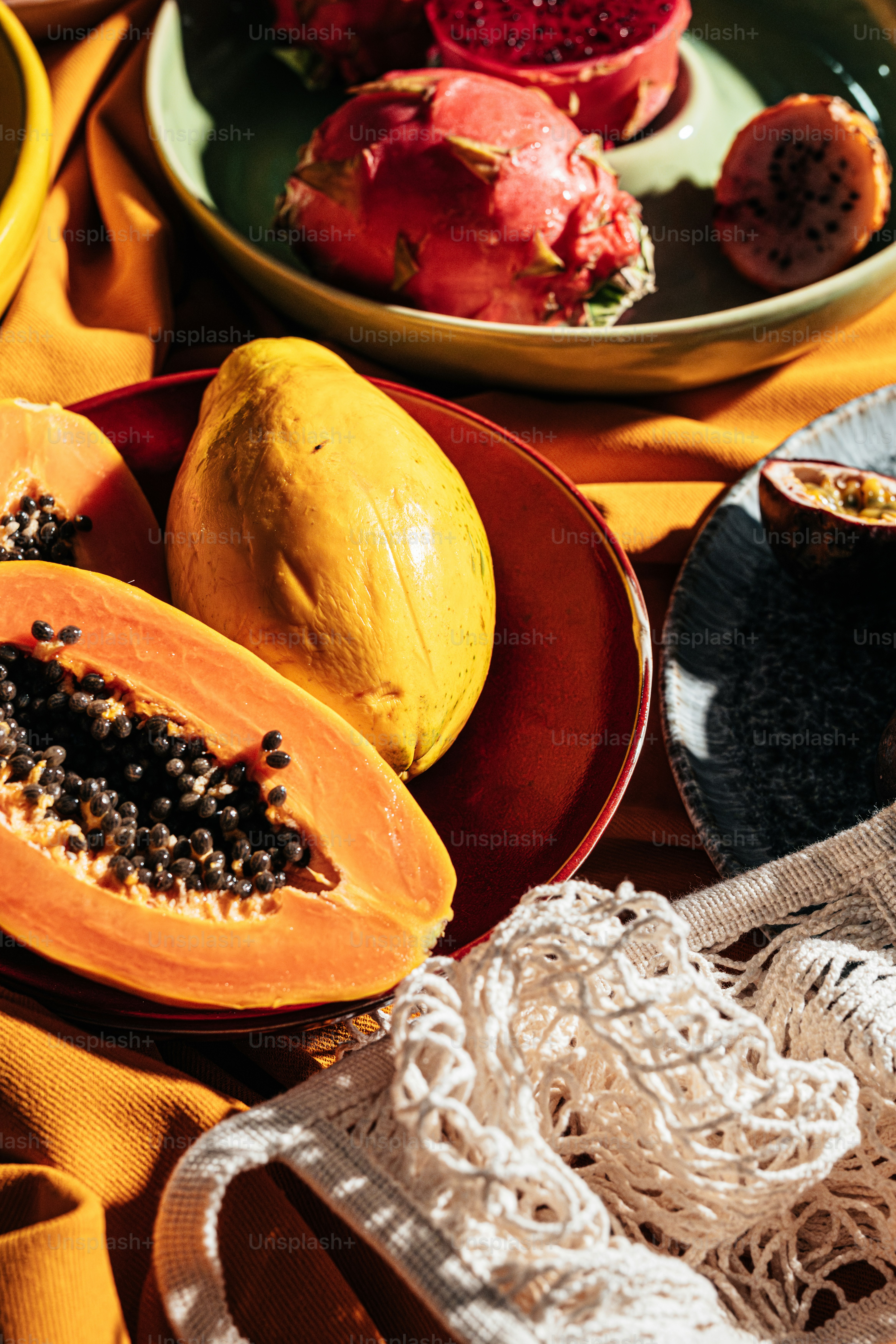 A table topped with plates and bowls filled with fruit