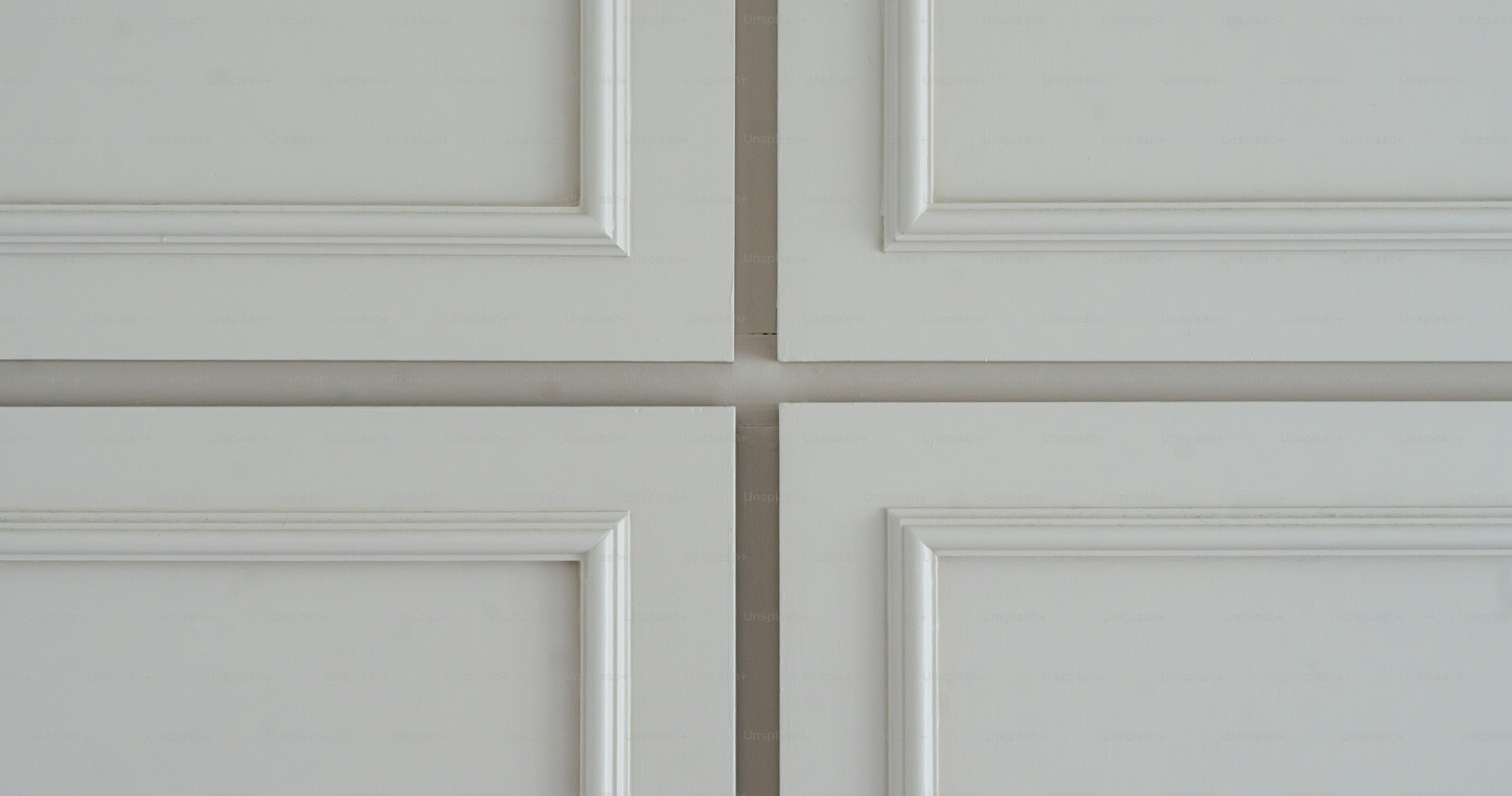 A close up of a white door with four panels