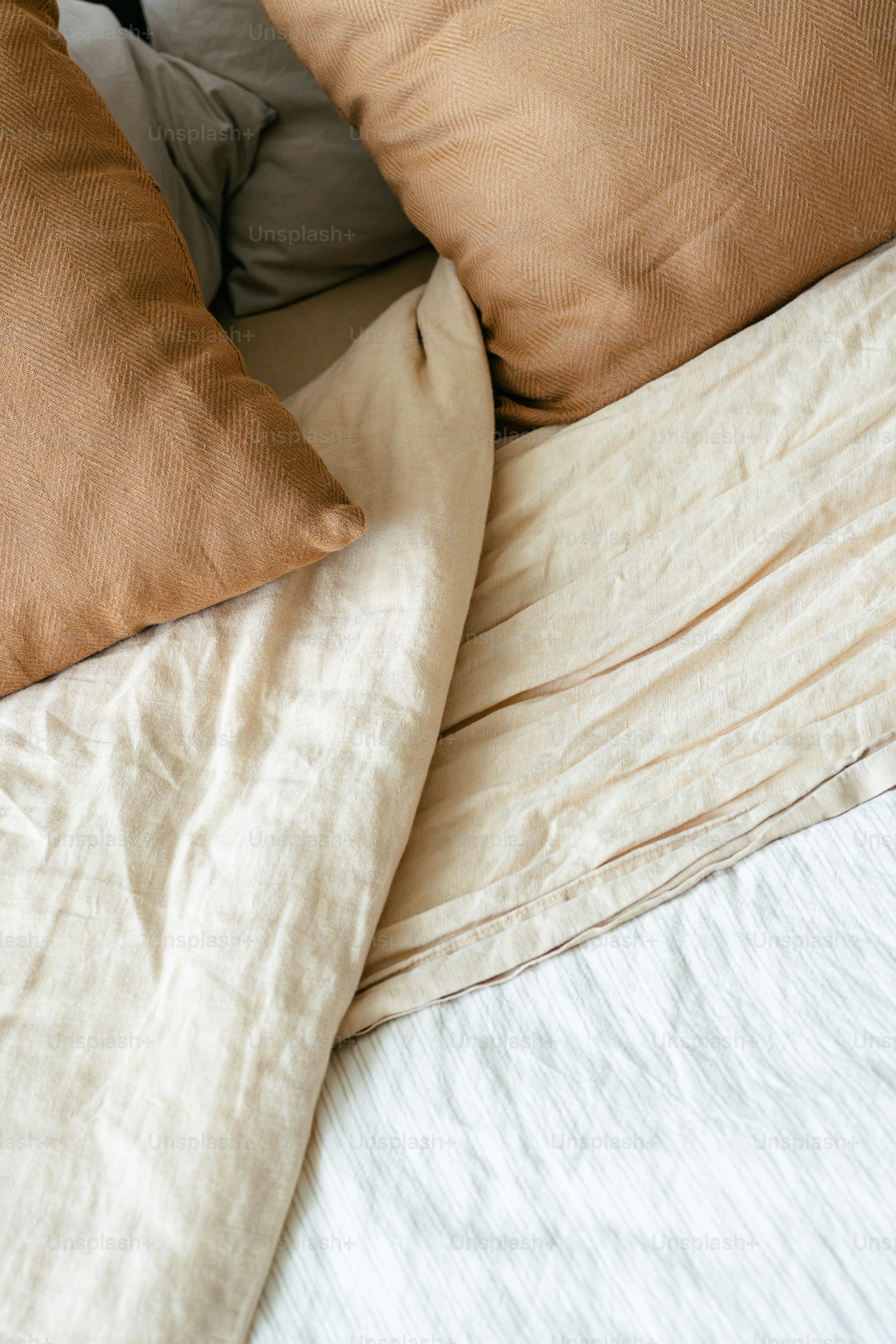 A bunch of pillows that are on a bed