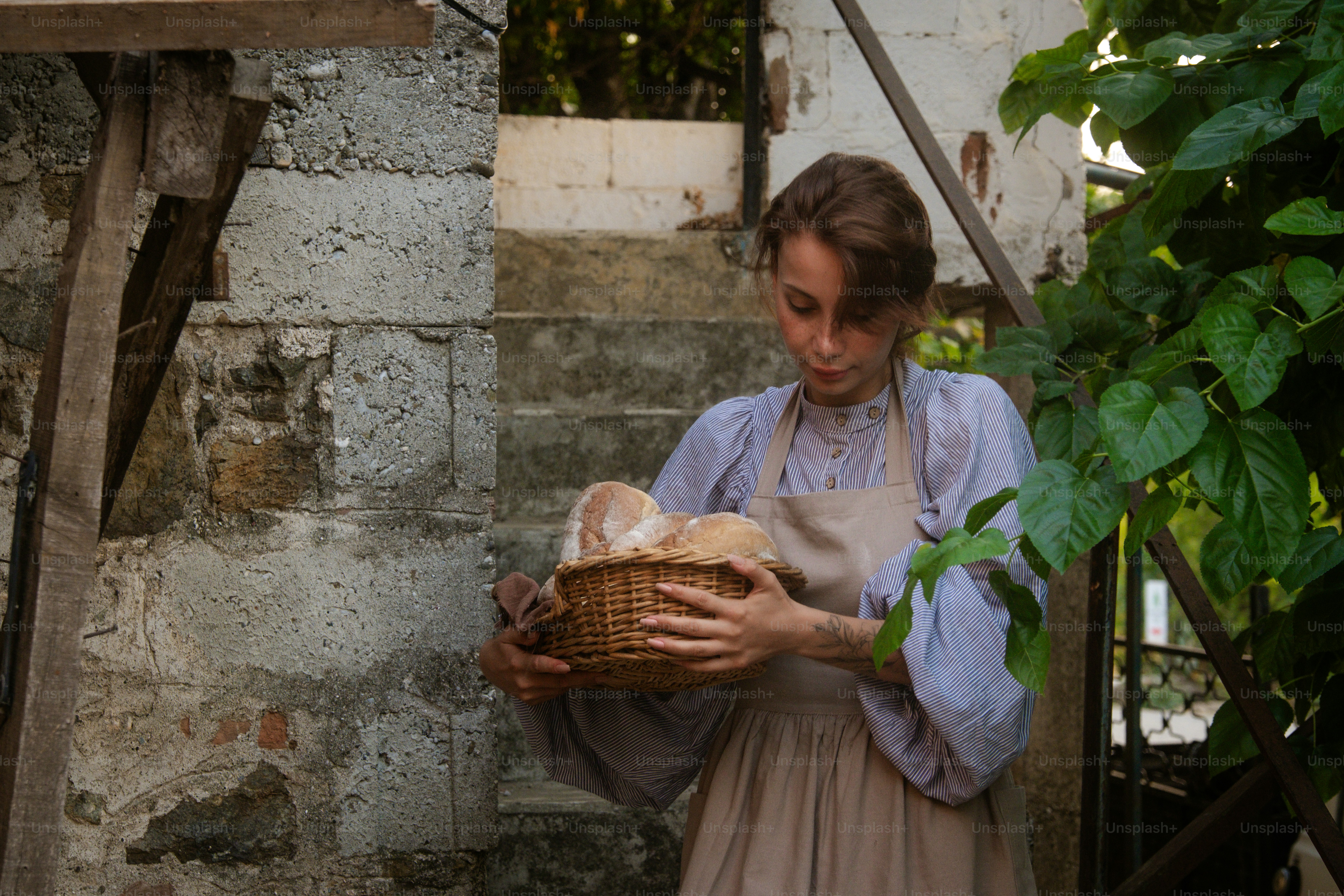 A woman holding a basket with a baby in it