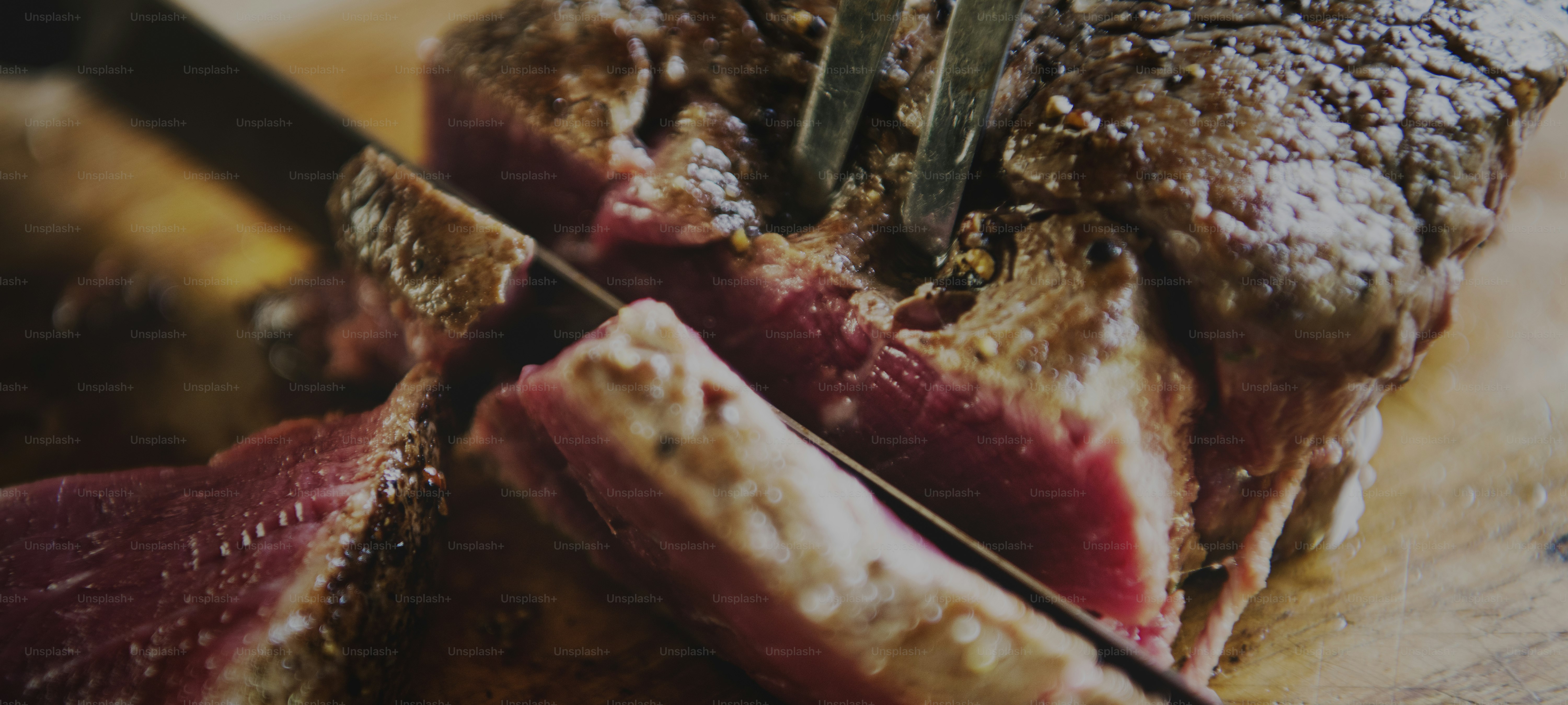 Cutting a cooked fillet steak food photography recipe idea