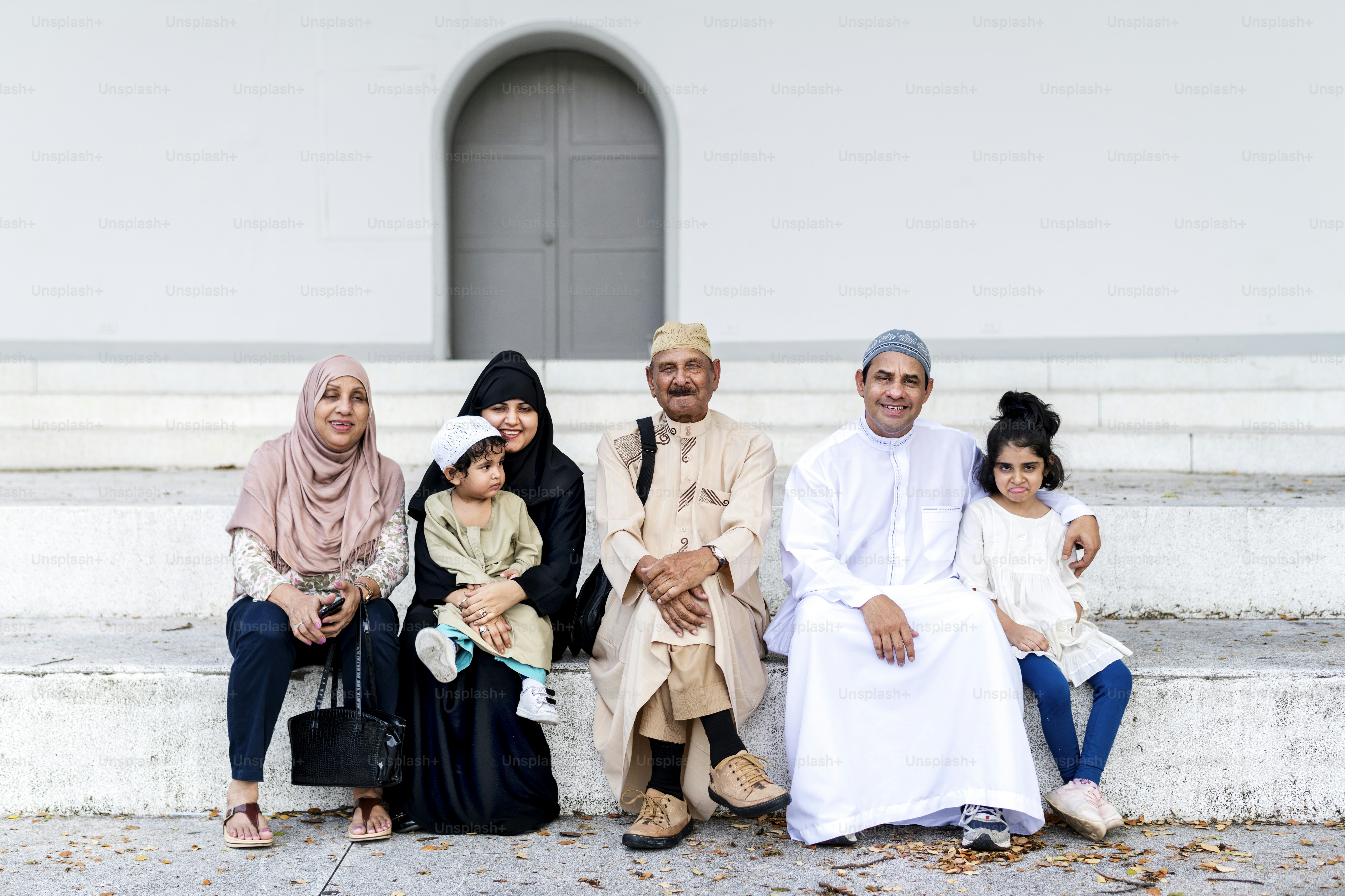 Muslim family sitting together outdoors
