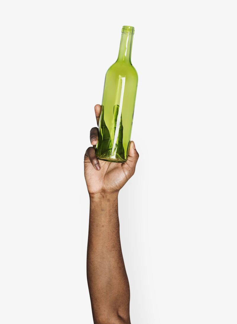 Hand holding a green glass herbal bottle