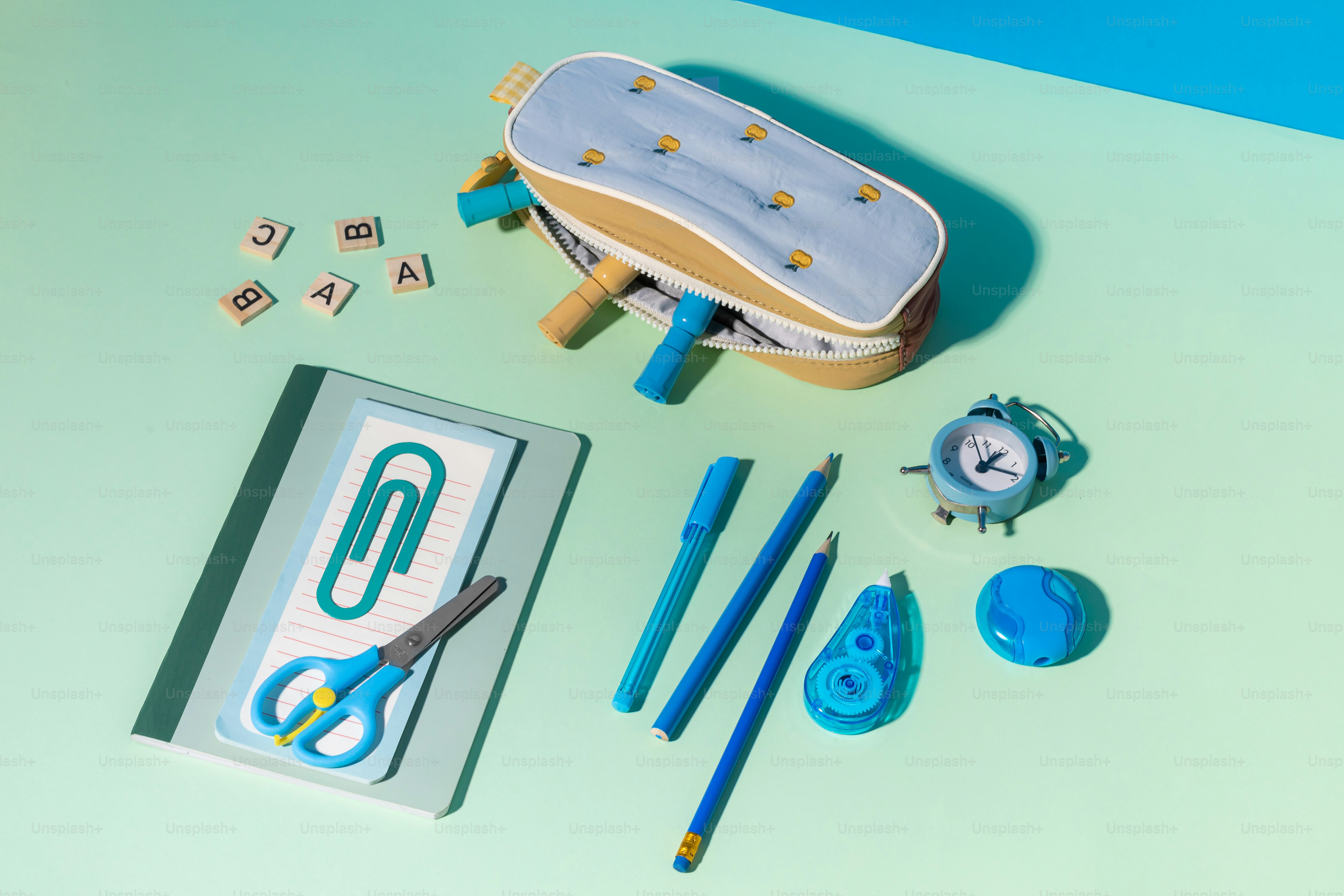 A toy skateboard, scissors, and other items on a table