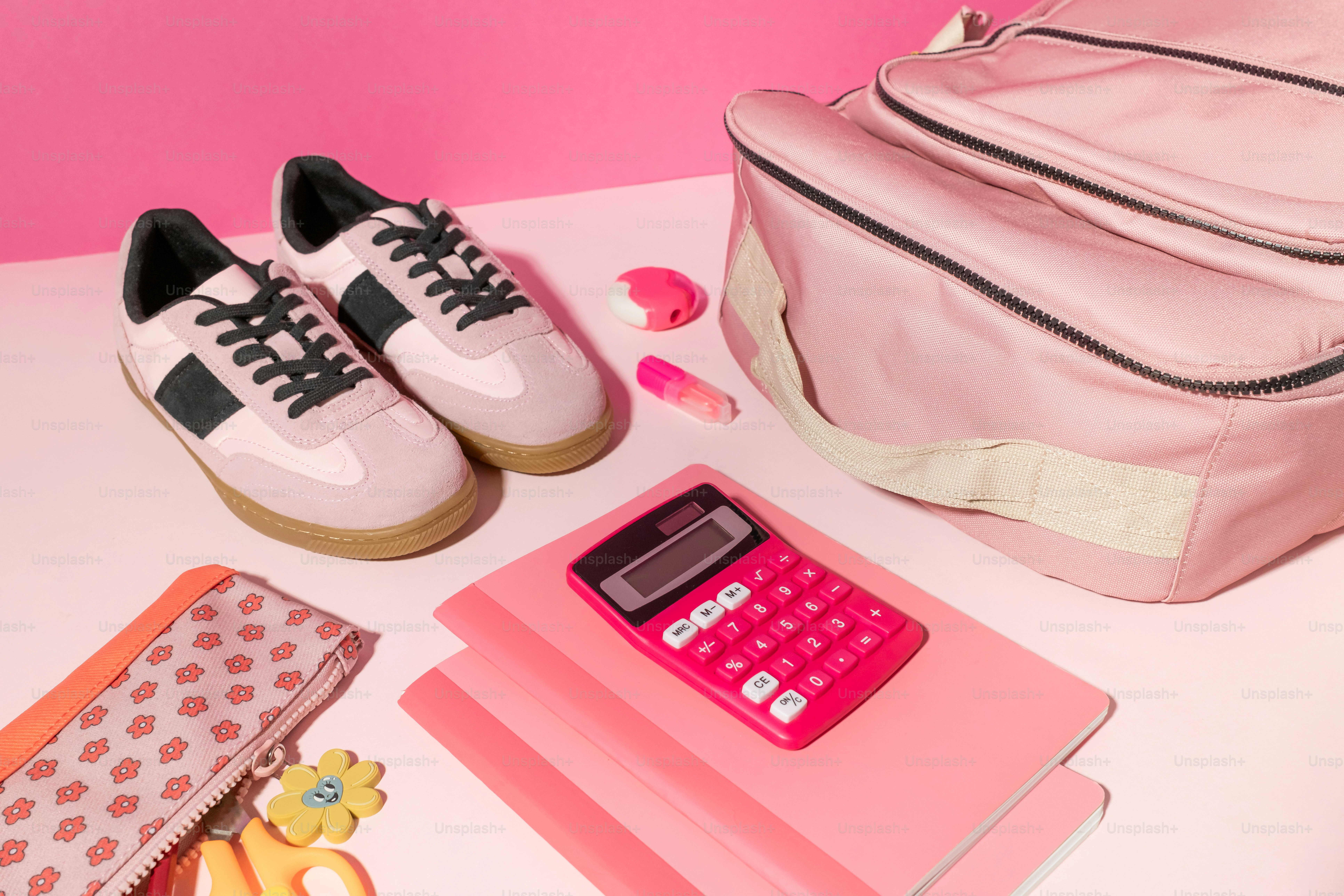 A pink backpack, a pink purse, a pink wallet, a pink phone,
