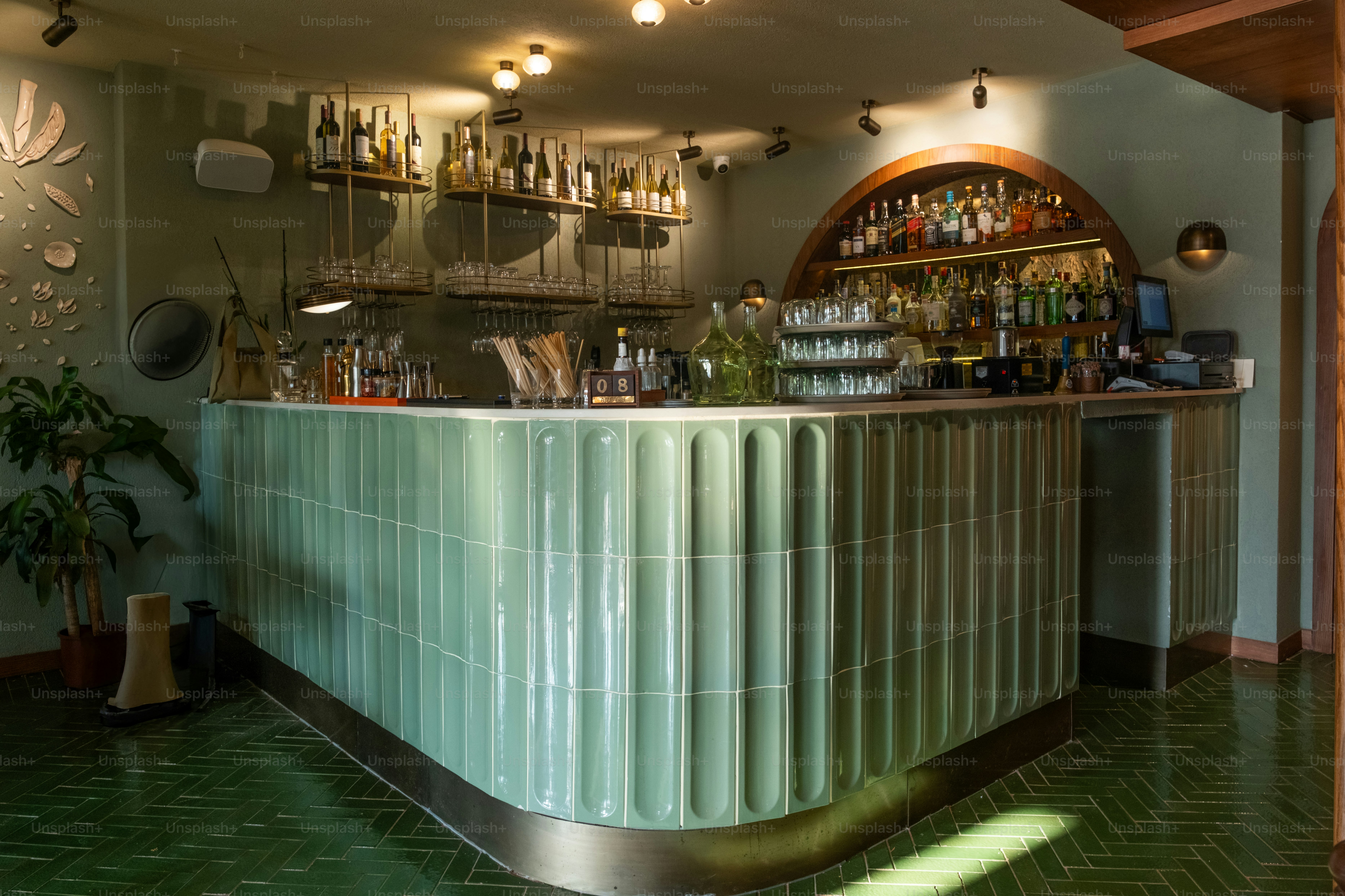 A restaurant with a green tiled floor and a bar