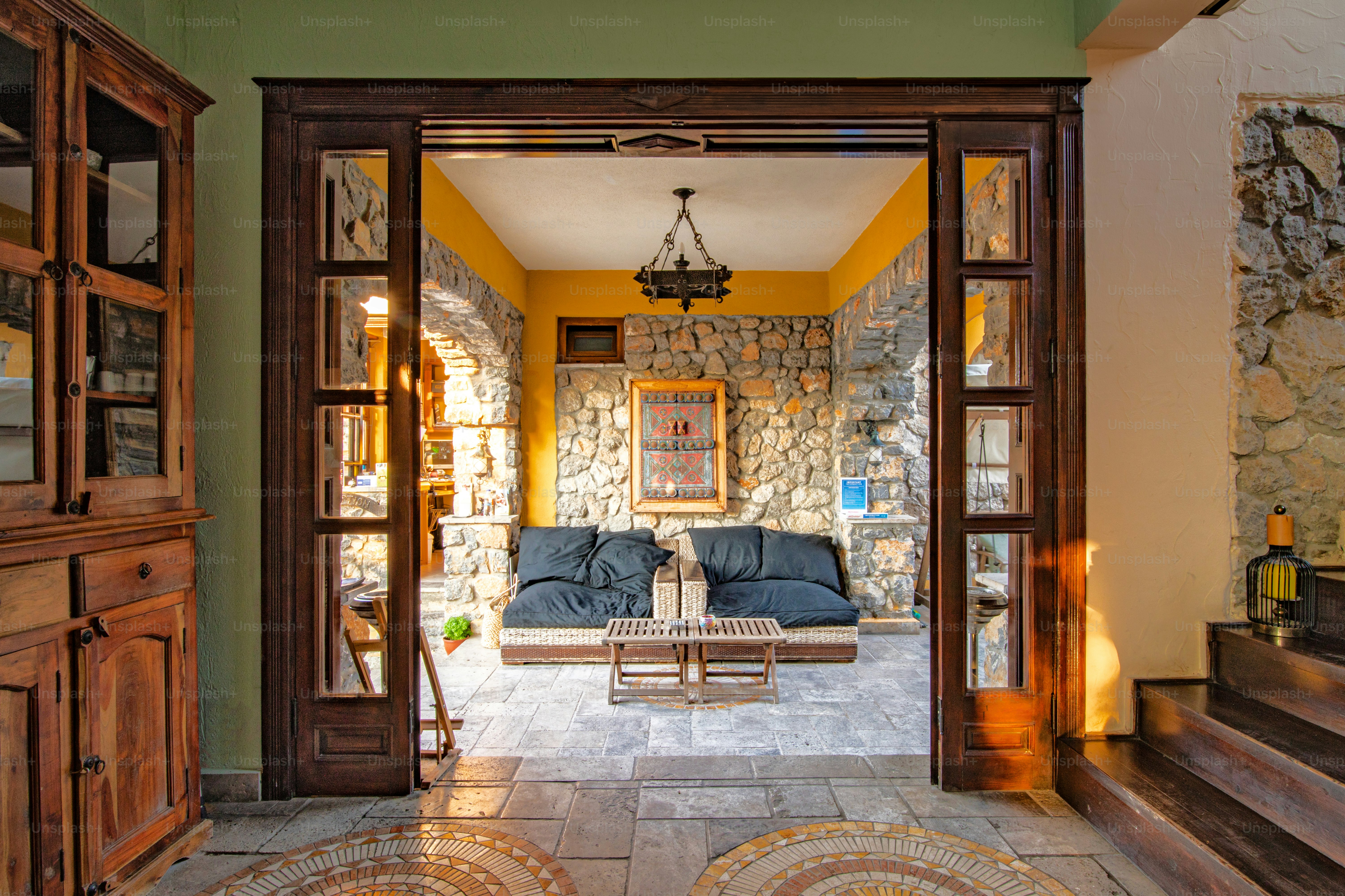 A living room filled with furniture and a stone wall