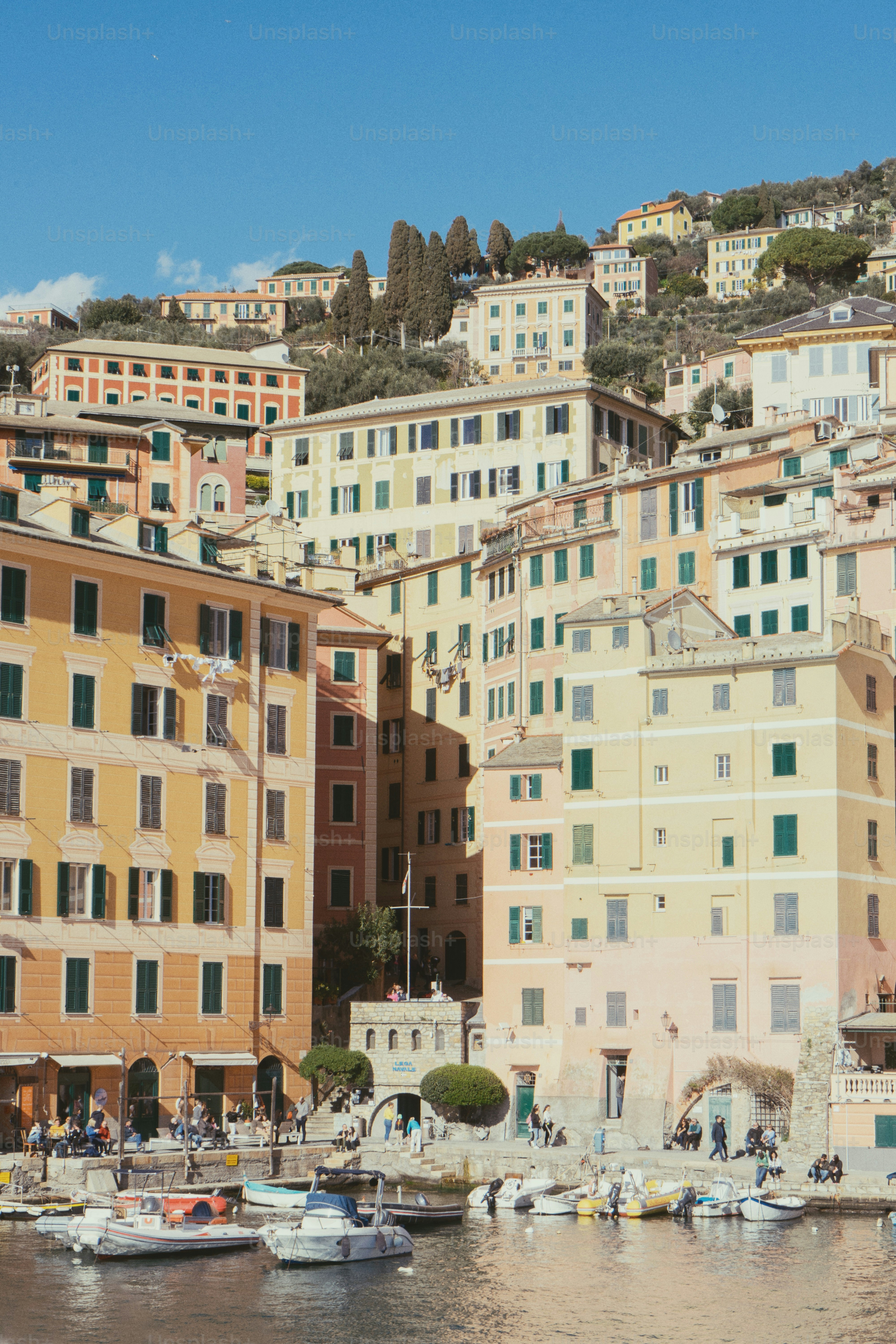 A harbor filled with lots of boats next to tall buildings