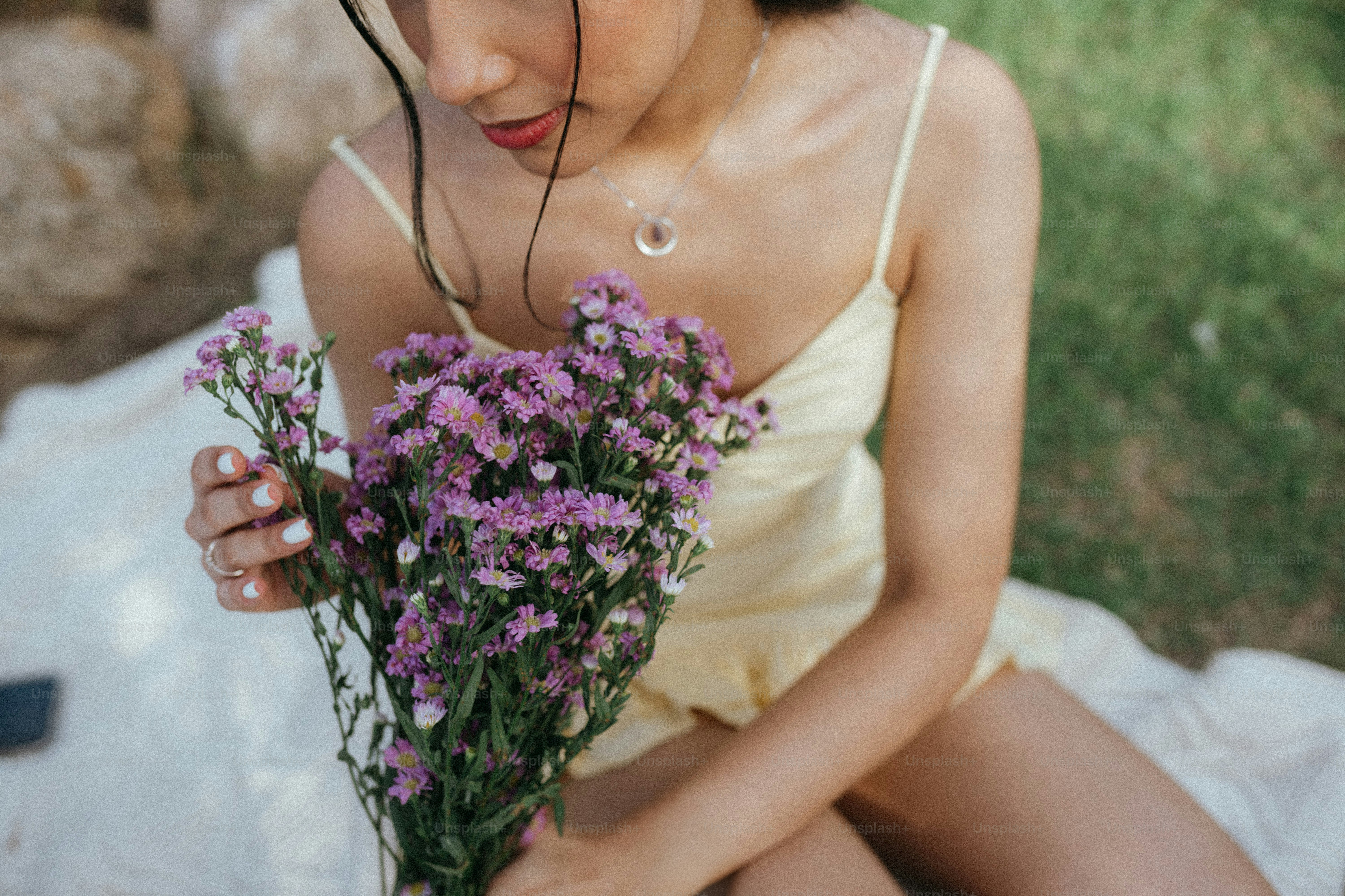 A woman in a yellow dress holding a bunch of flowers photo – Bouquet ...