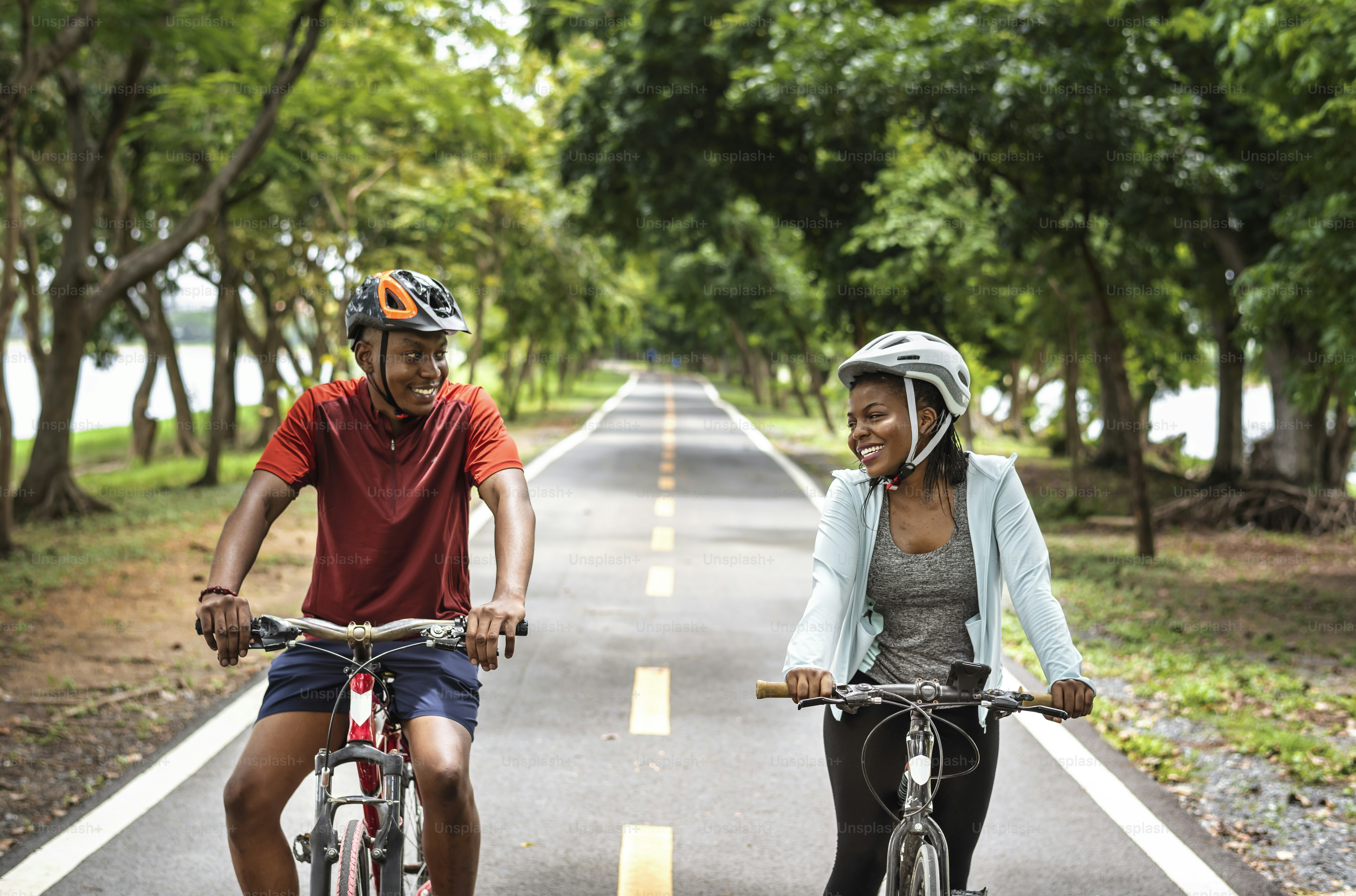 Cyclist couple riding together in a park