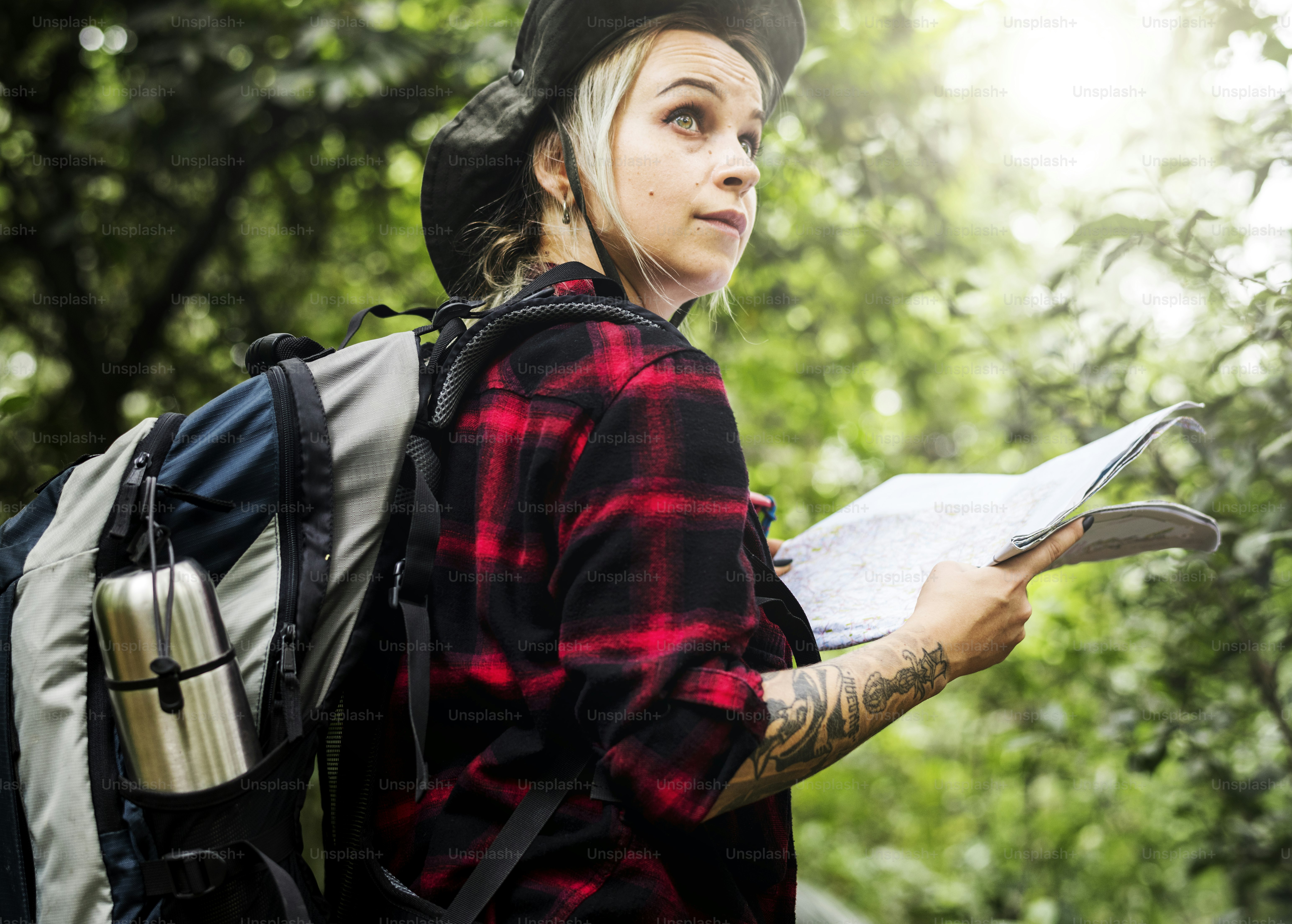 Backpacker using mobile trail navigation app while reviewing a route before departu