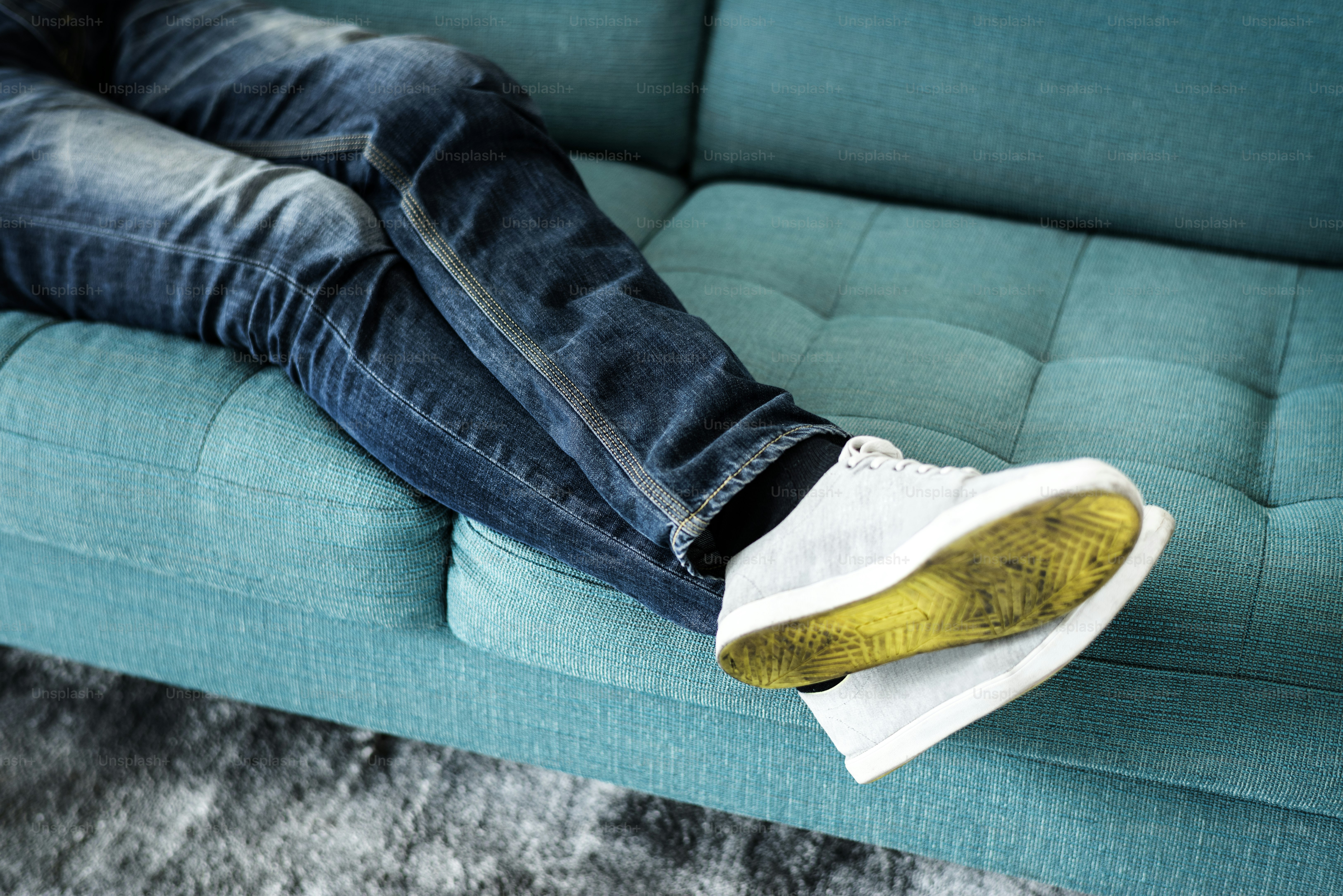 Closeup pair of legs lying on the sofa