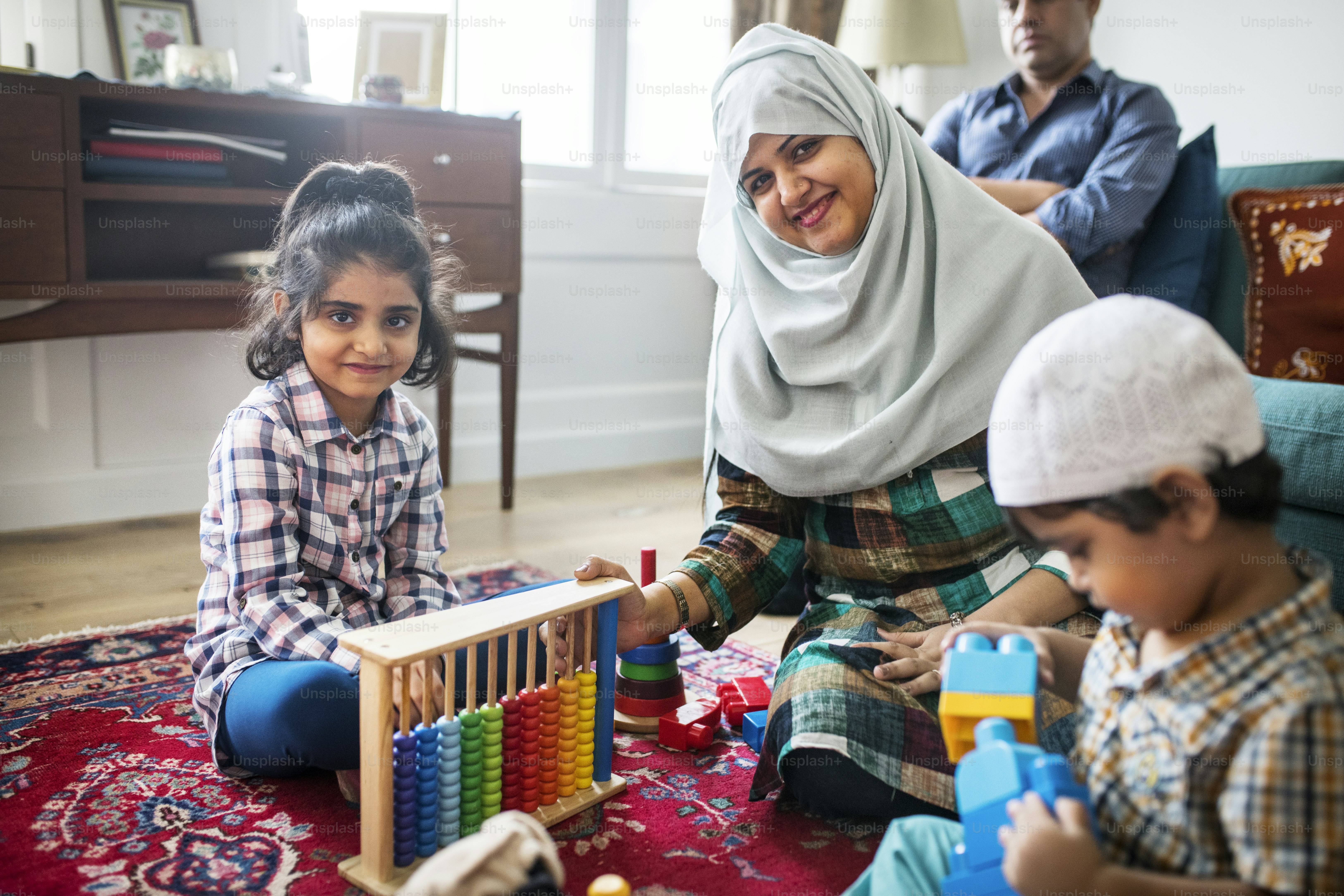 Muslim family relaxing and playing at home