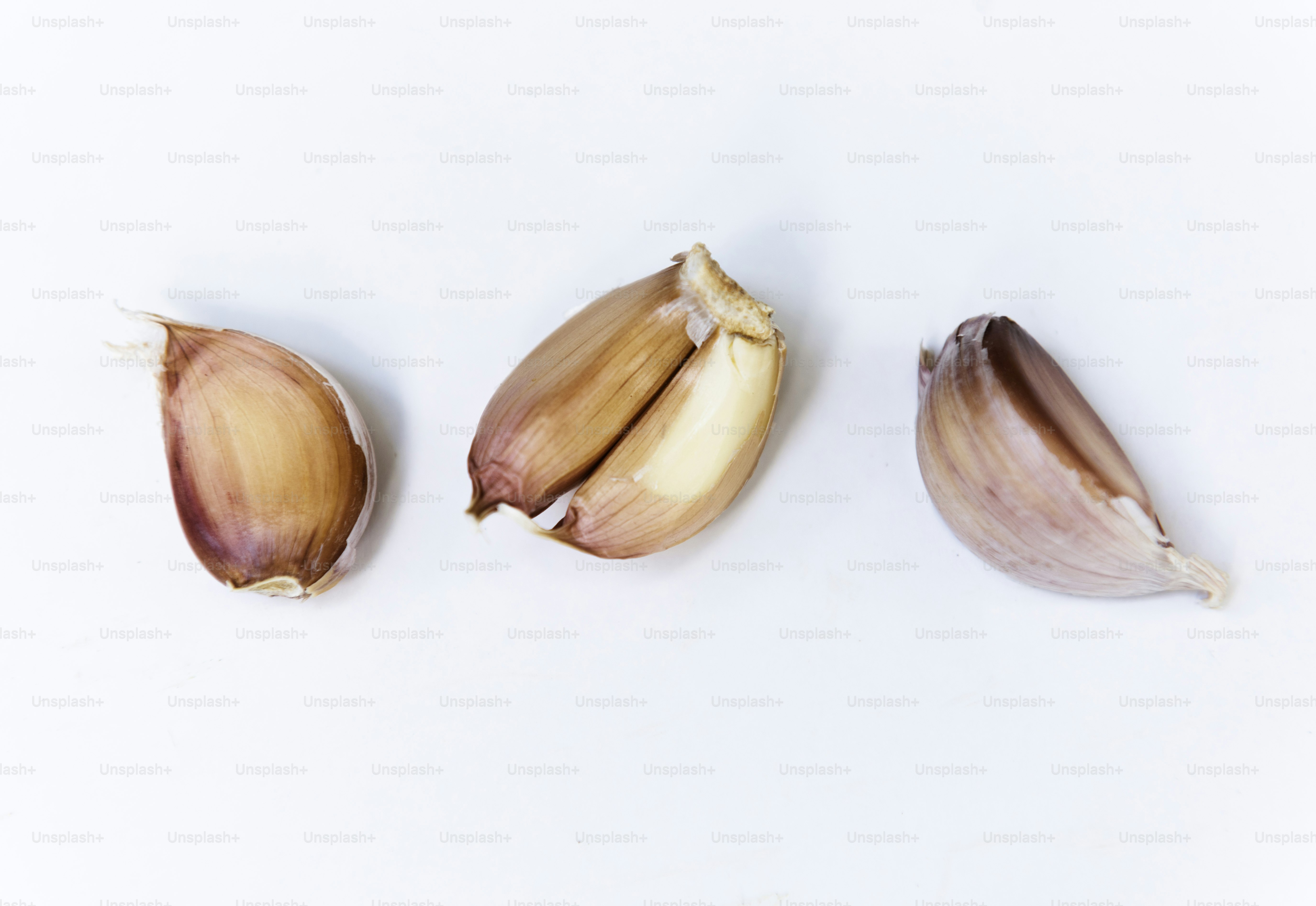 Closeup of garlic cloves on white background