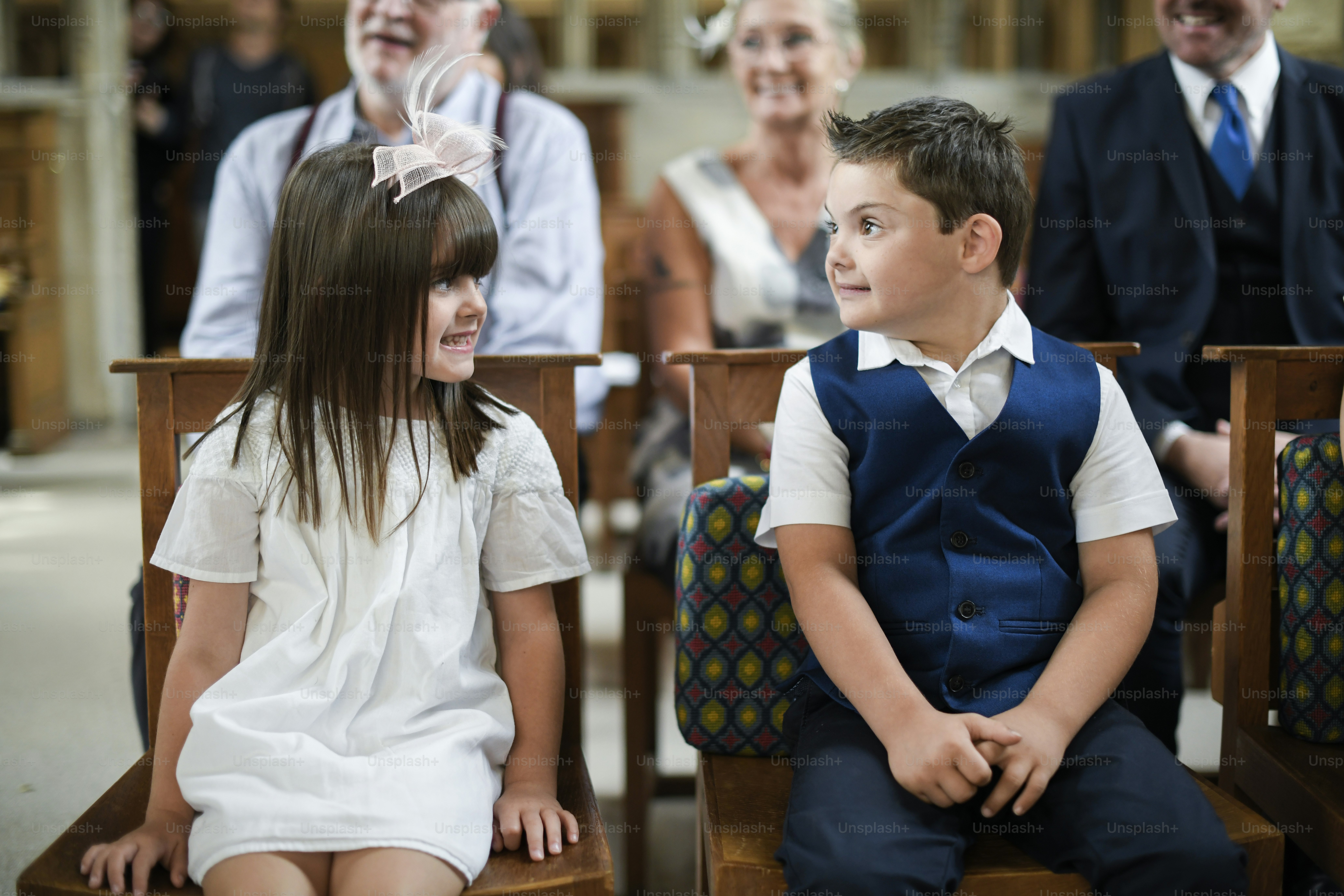 Two little kids at a wedding ceremony