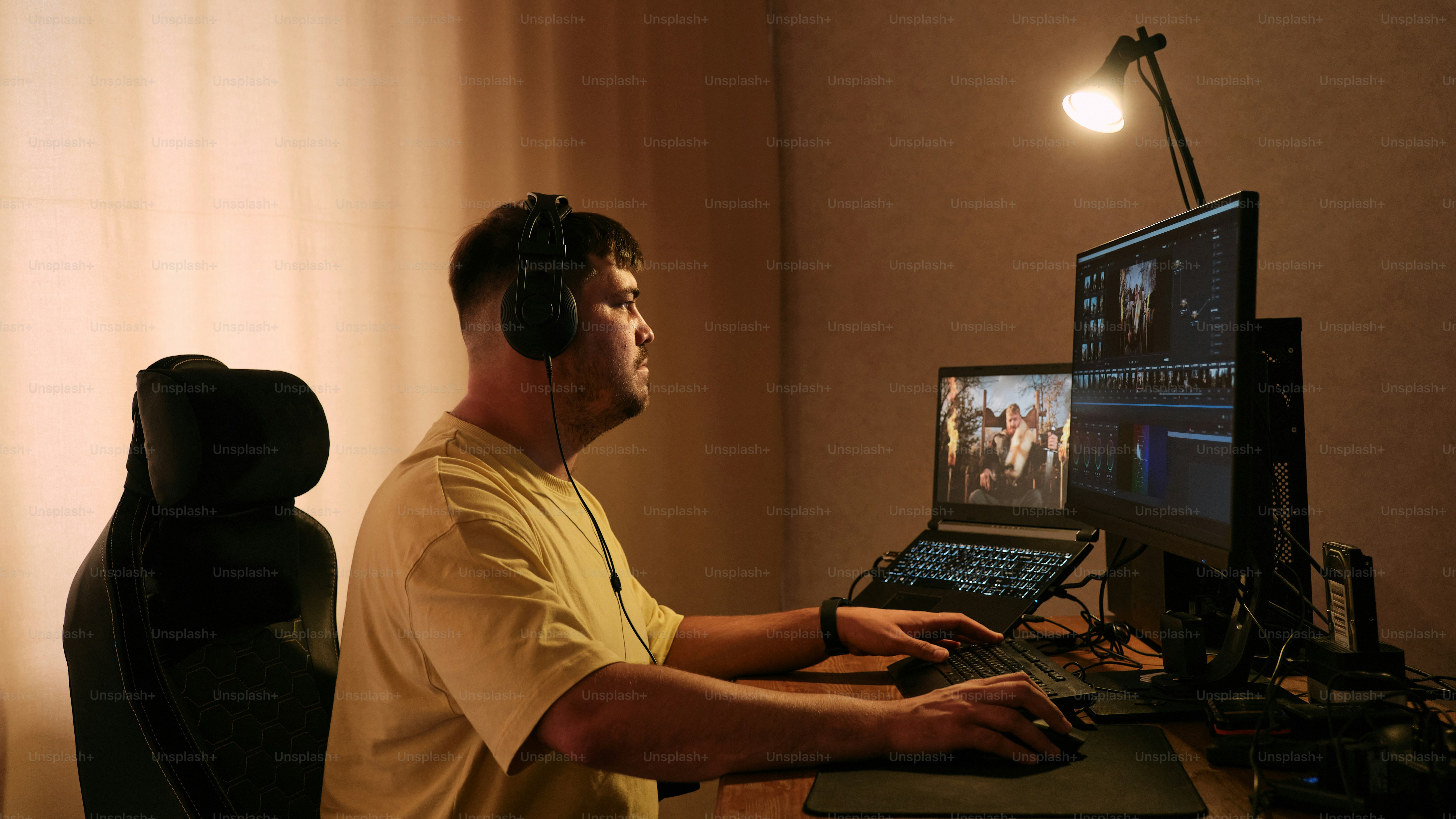 A man sitting in front of a computer monitor