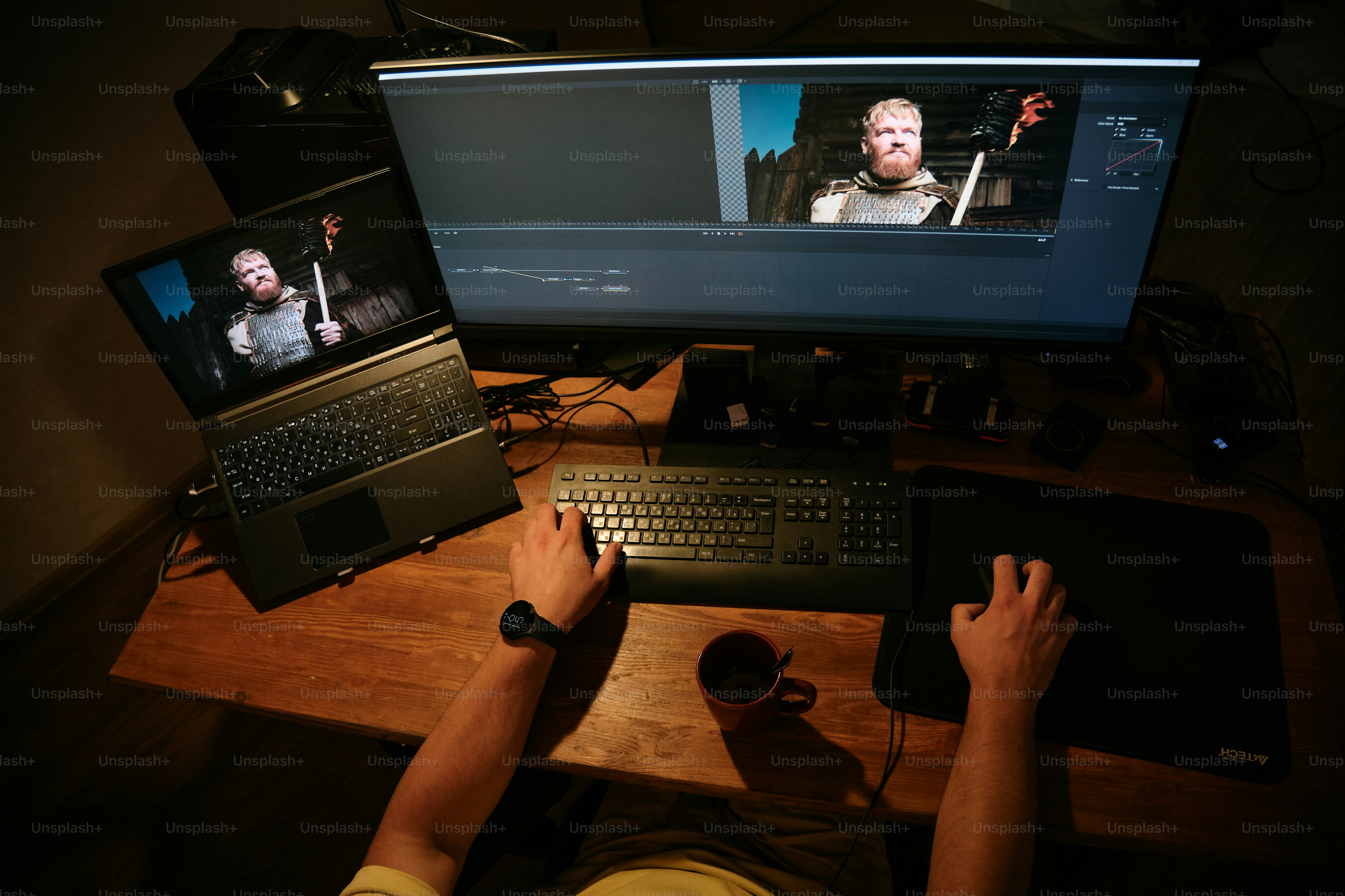 A video editor at work with multiple screens