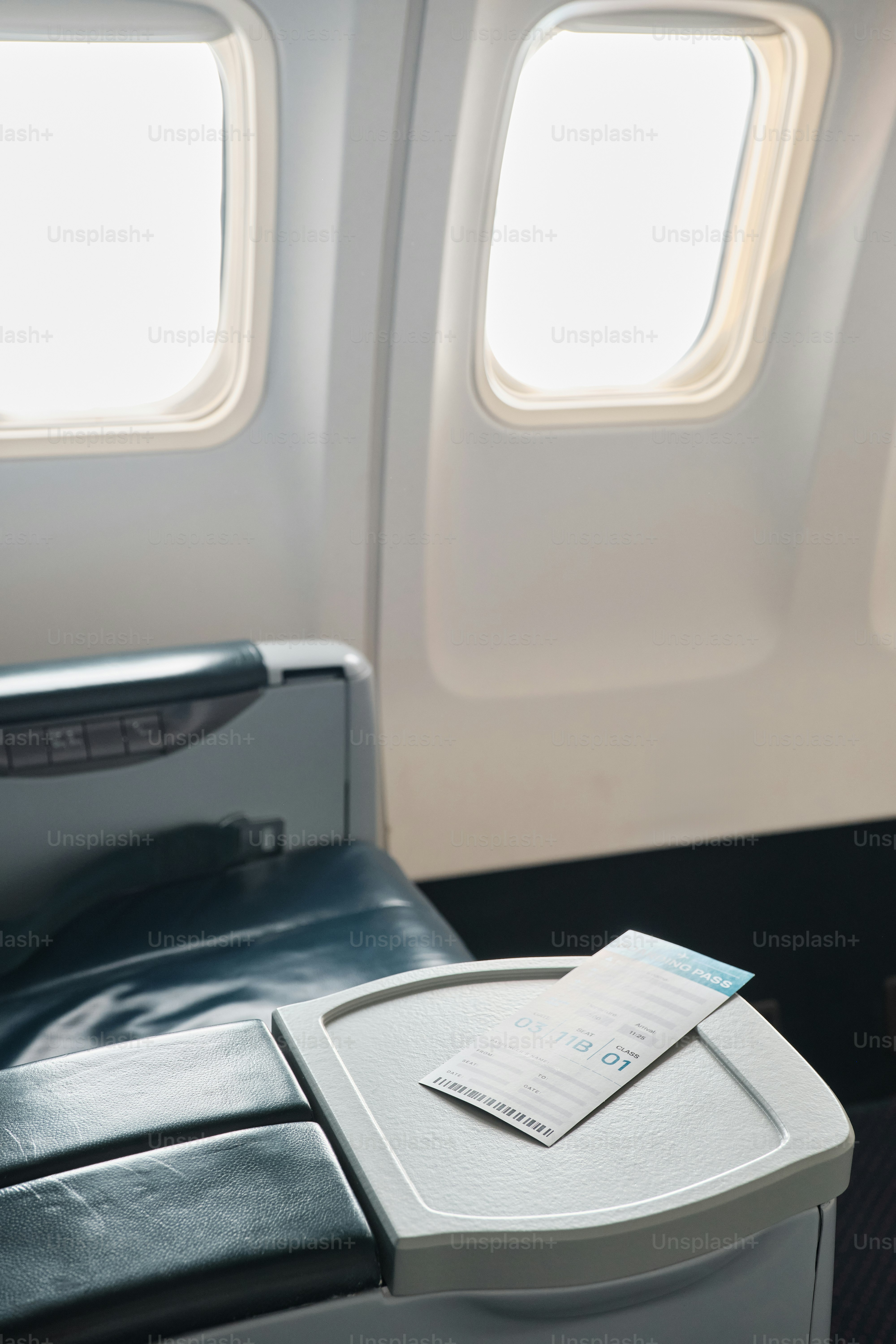 A seat on an airplane with a piece of paper on it