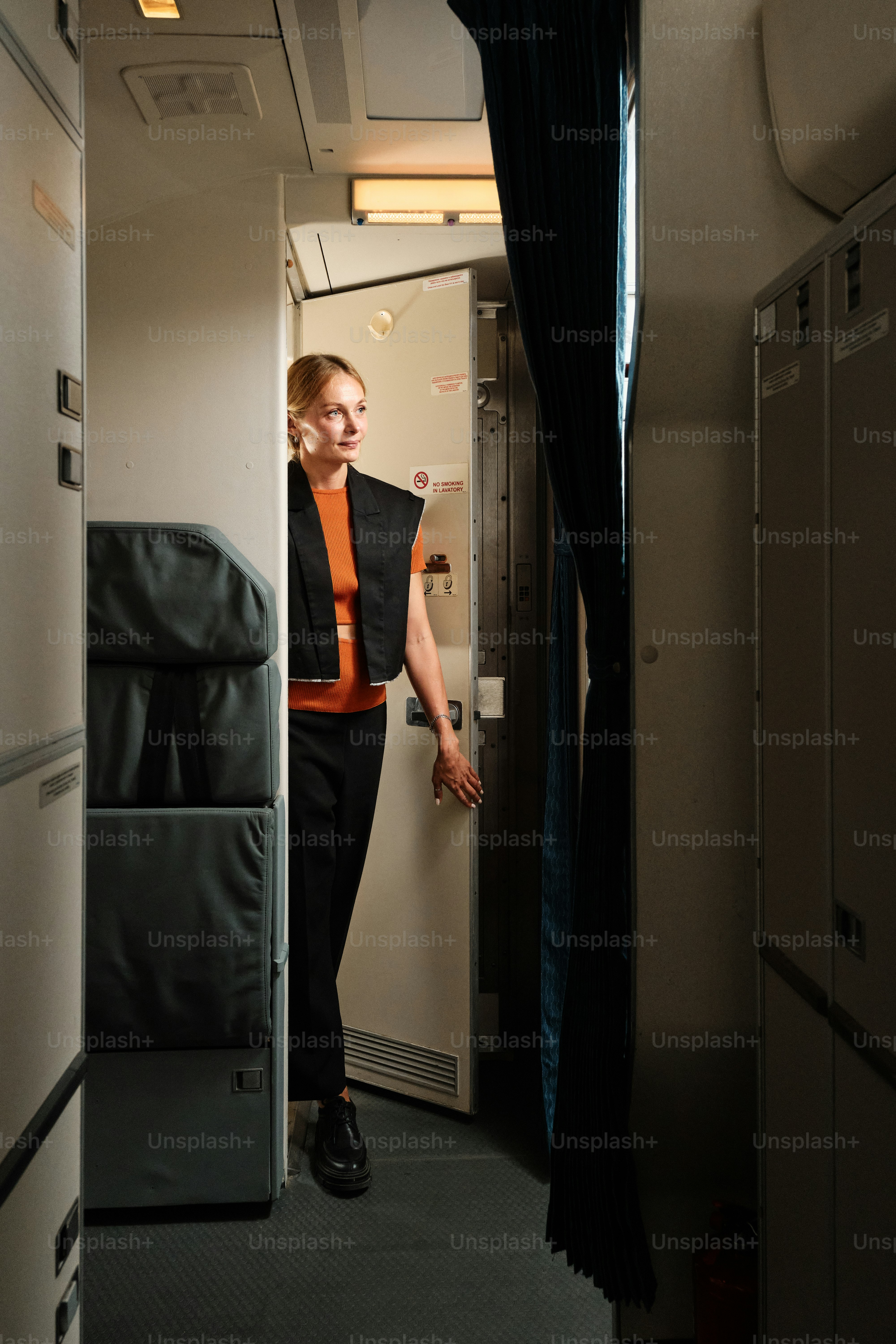 A man standing in the doorway of an airplane