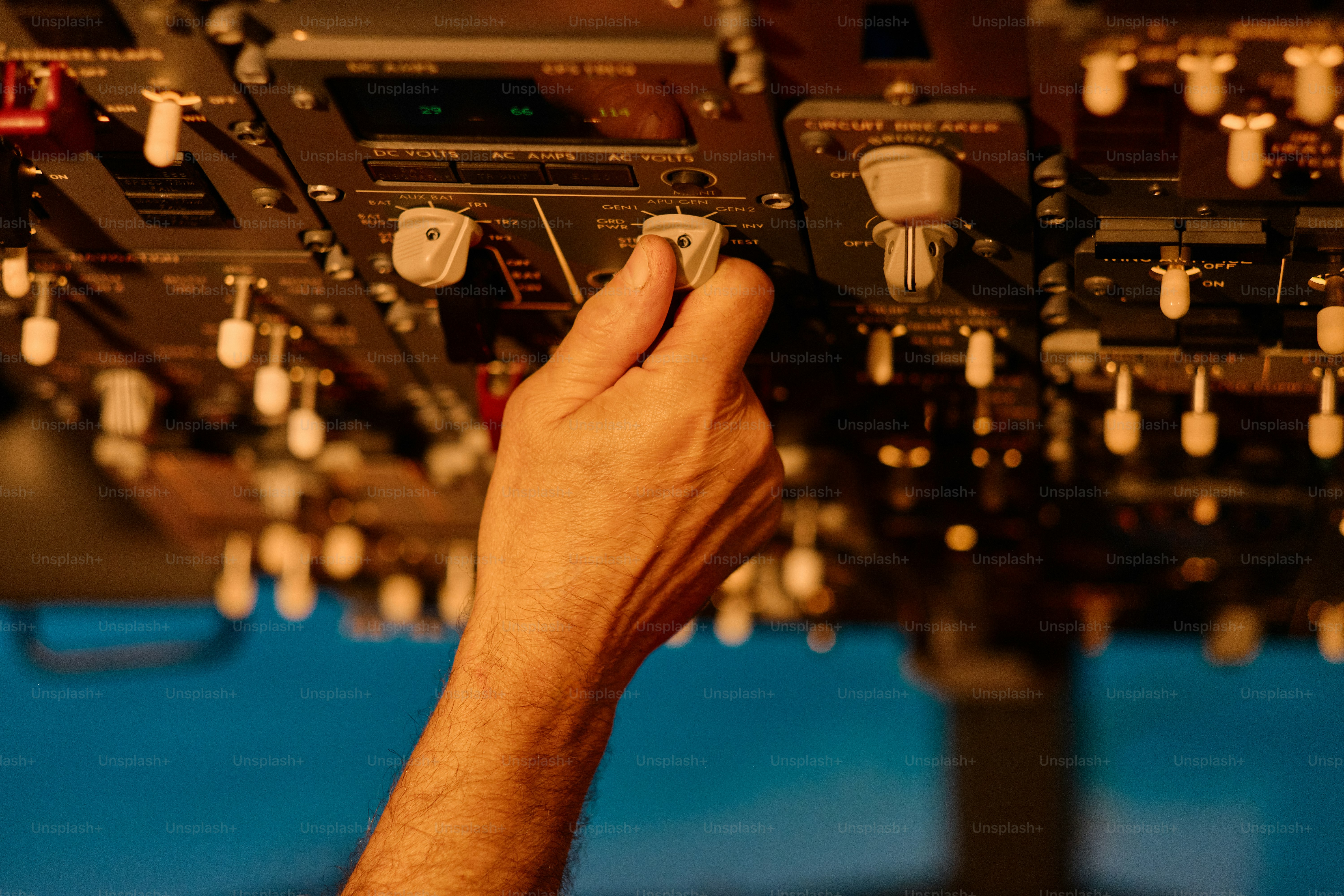 A man is working on a control panel